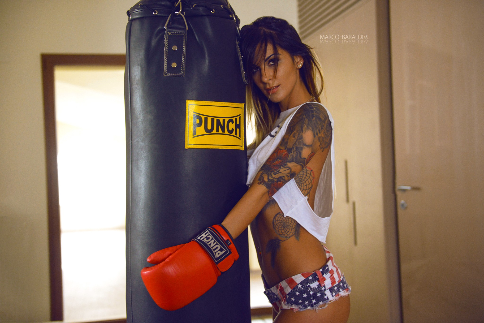 People 2048x1367 women shorts tattoo boxing gloves brunette T-shirt nose ring punching bag gym clothes jean shorts Marco Baraldi fitness model women indoors indoors inked girls watermarked short shorts hair in face model