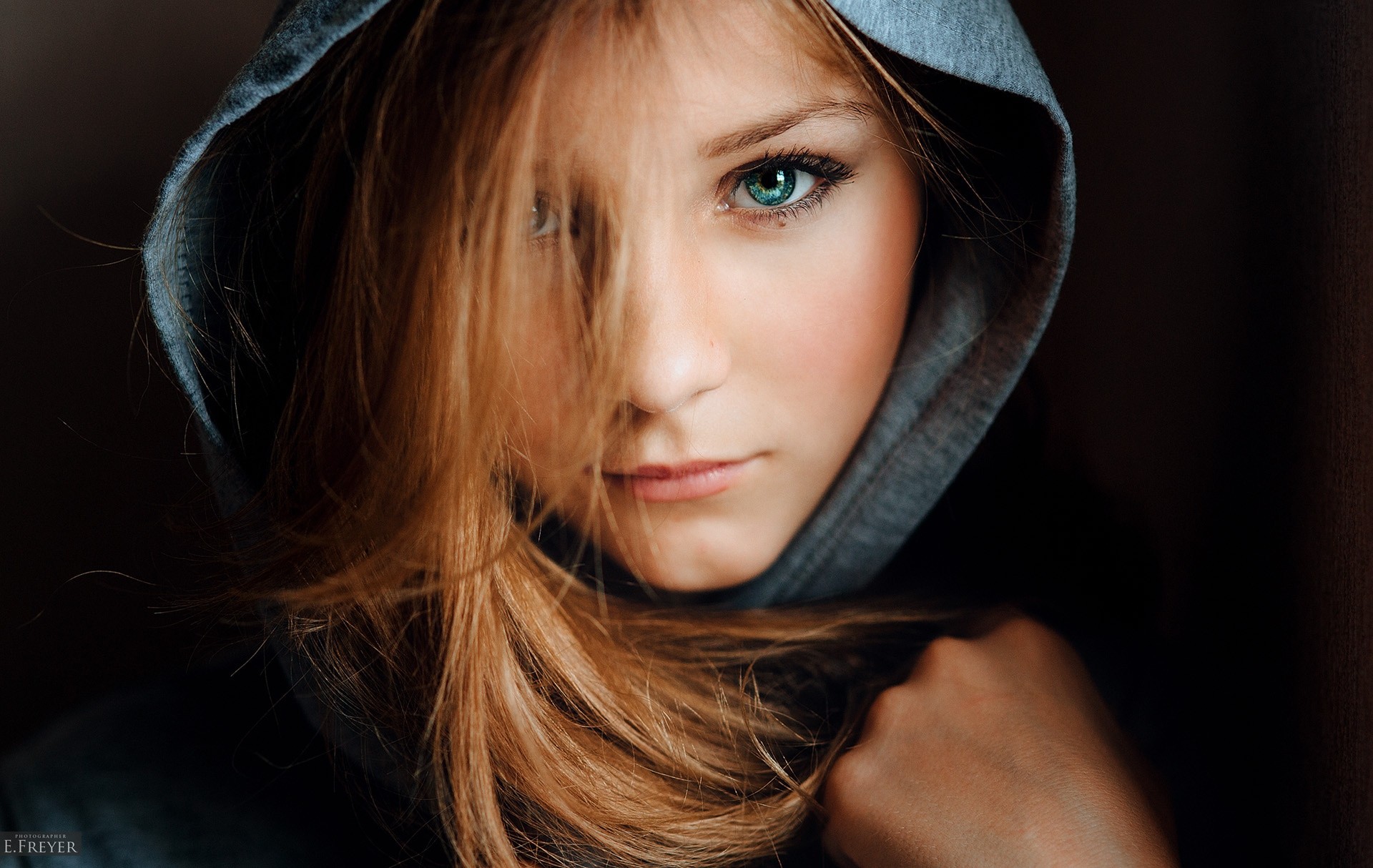 People 1920x1214 women blonde hoods eyes simple background Evgeny Freyer hair in face closeup looking at viewer face model women indoors indoors watermarked Christina Vostruhina young women