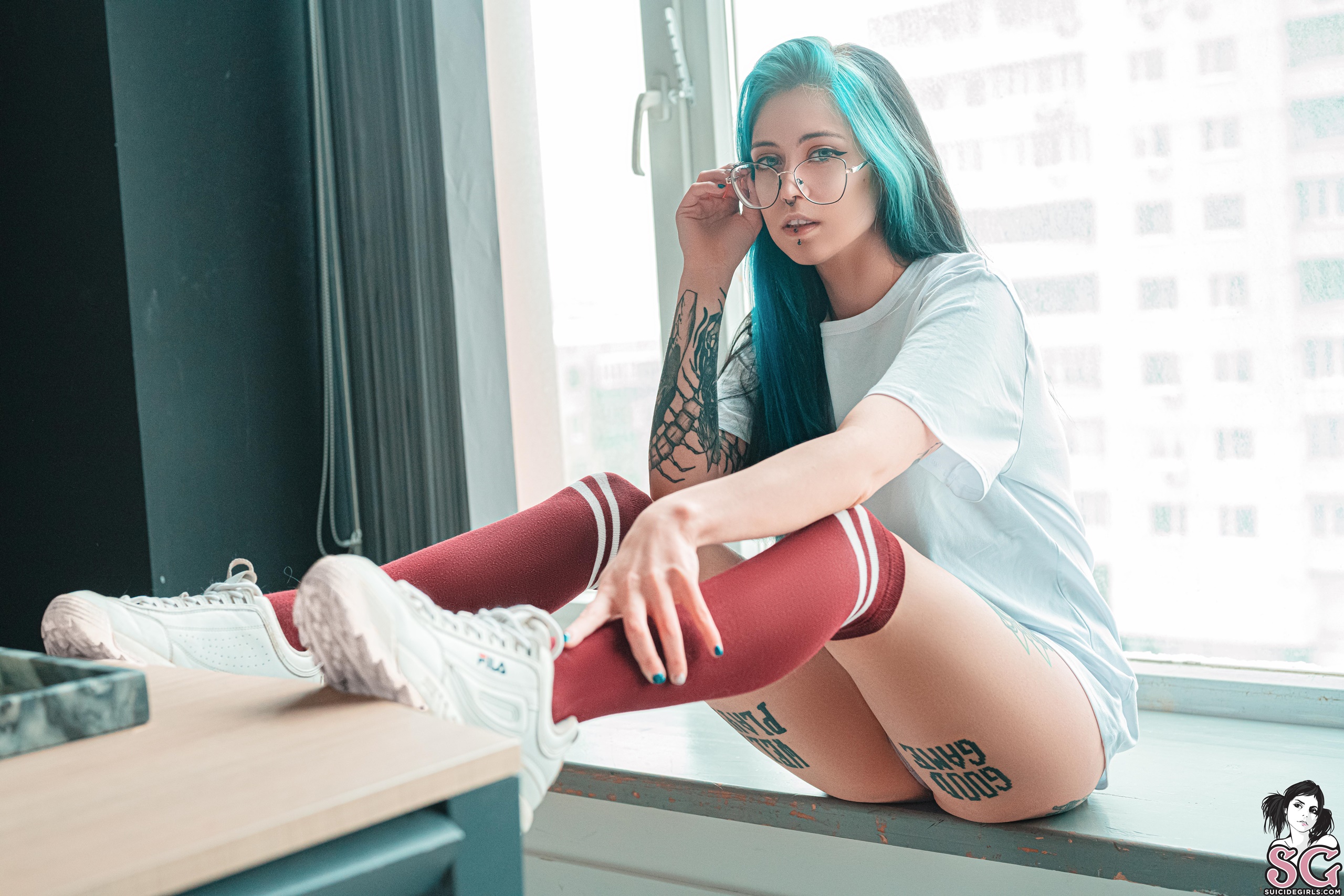 People 2560x1707 Frutella Suicide blue hair dyed hair women indoors Suicide Girls model tattoo inked girls women looking at viewer blue eyes women with glasses shirt stockings piercing window bokeh sitting T-shirt white tops