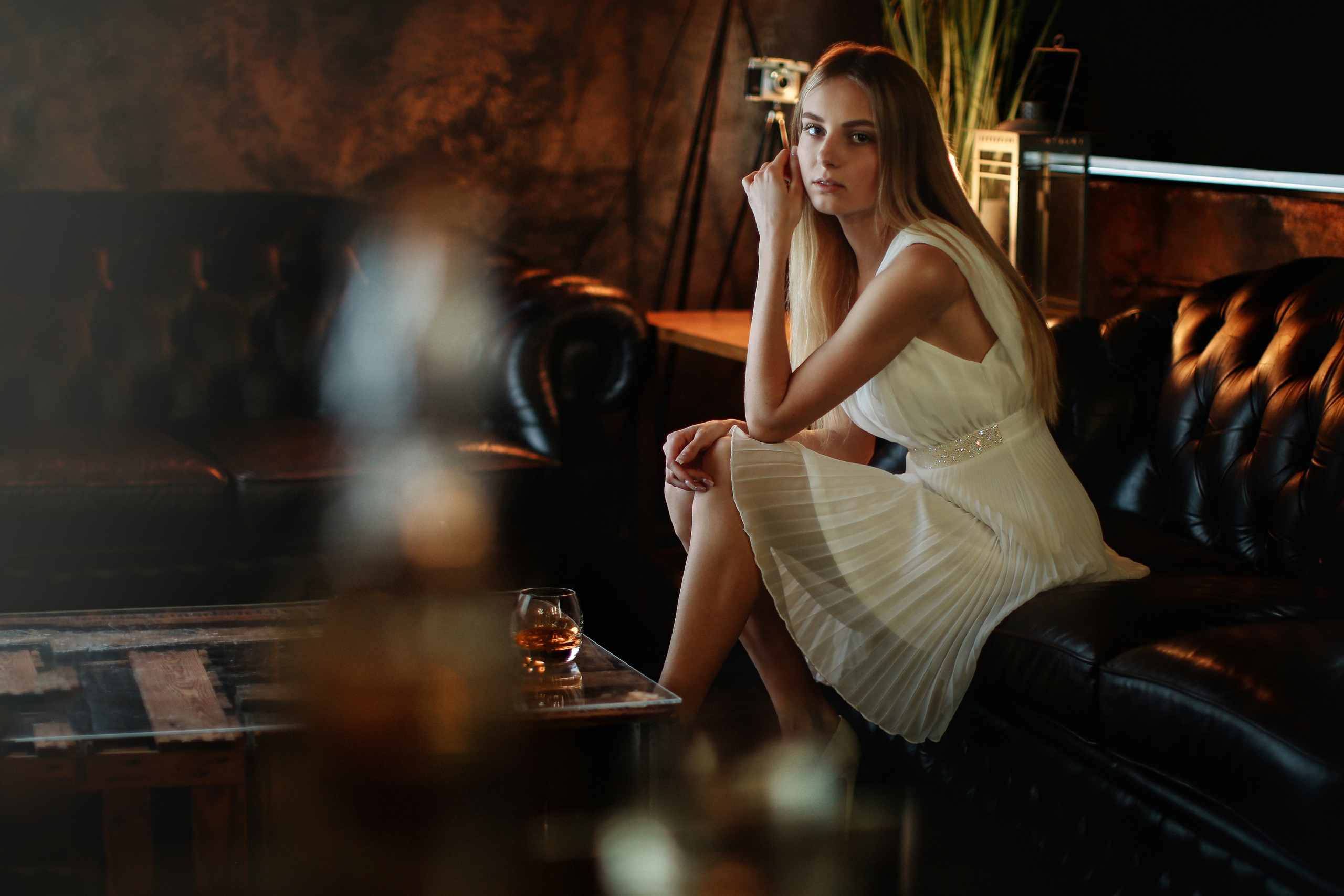 People 2560x1707 model indoors women women indoors sitting dress white dress looking at viewer cocktails classy on sofa black couch leather couch drinking glass hand on leg one arm up open mouth glamour girls