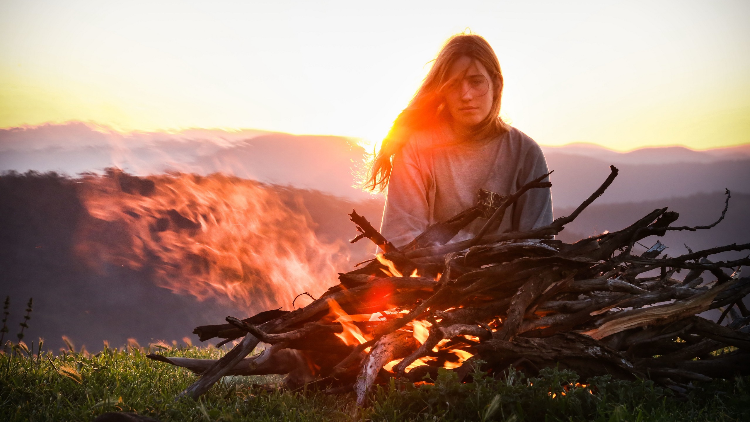 People 2560x1440 women outdoors women outdoors fire wood burning nature long hair looking at viewer campfire overexposed