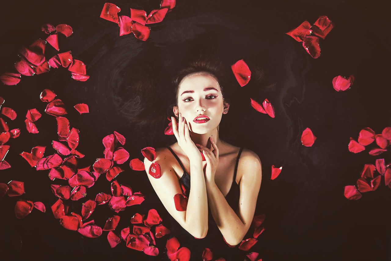 People 1280x853 women model looking at viewer brunette rose petals lipstick red lipstick touching face natural light water in water black clothing makeup earring