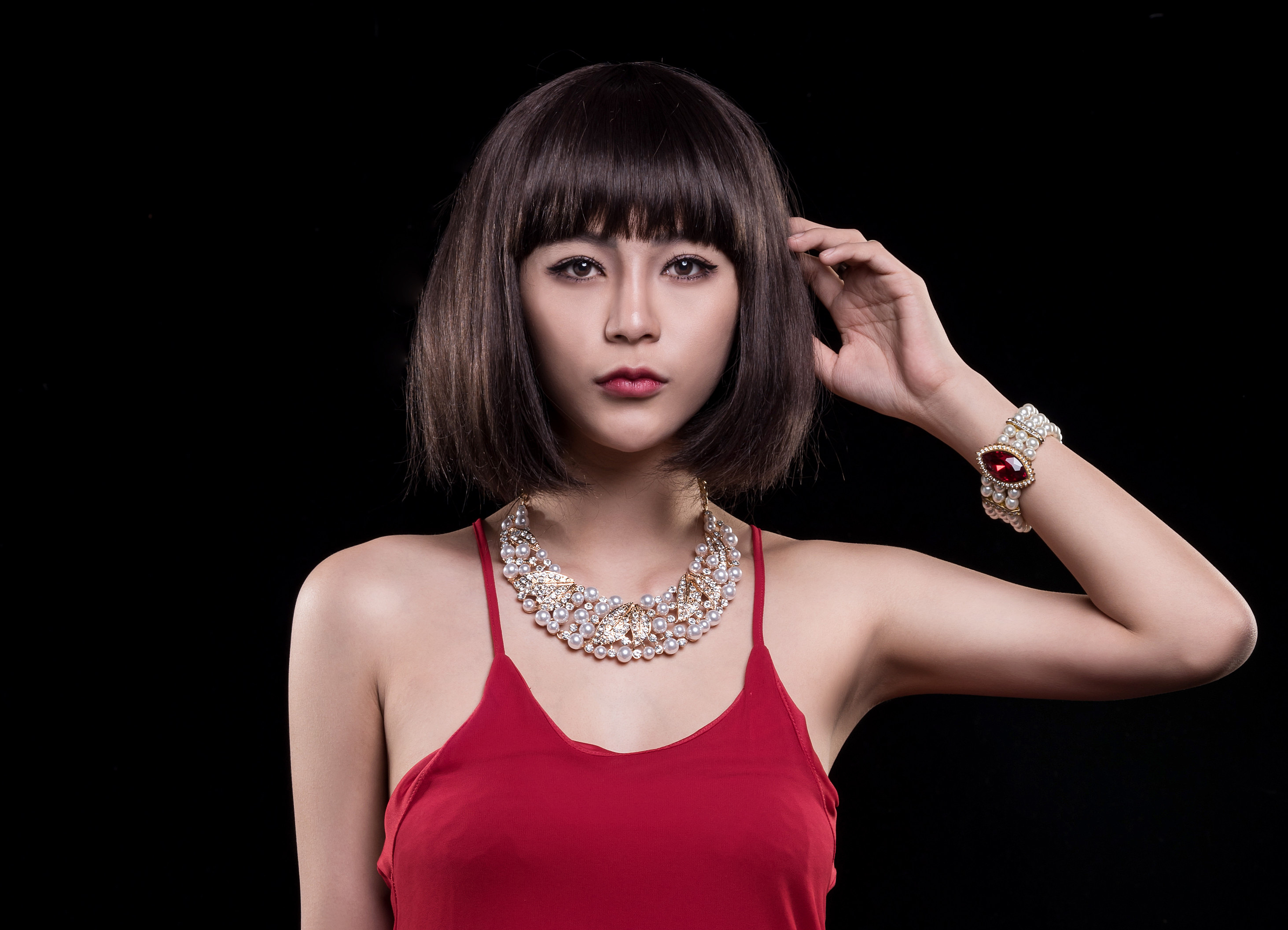 People 2926x2114 Asian model women brunette necklace short hair looking into the distance bracelets red tops black background frontal view