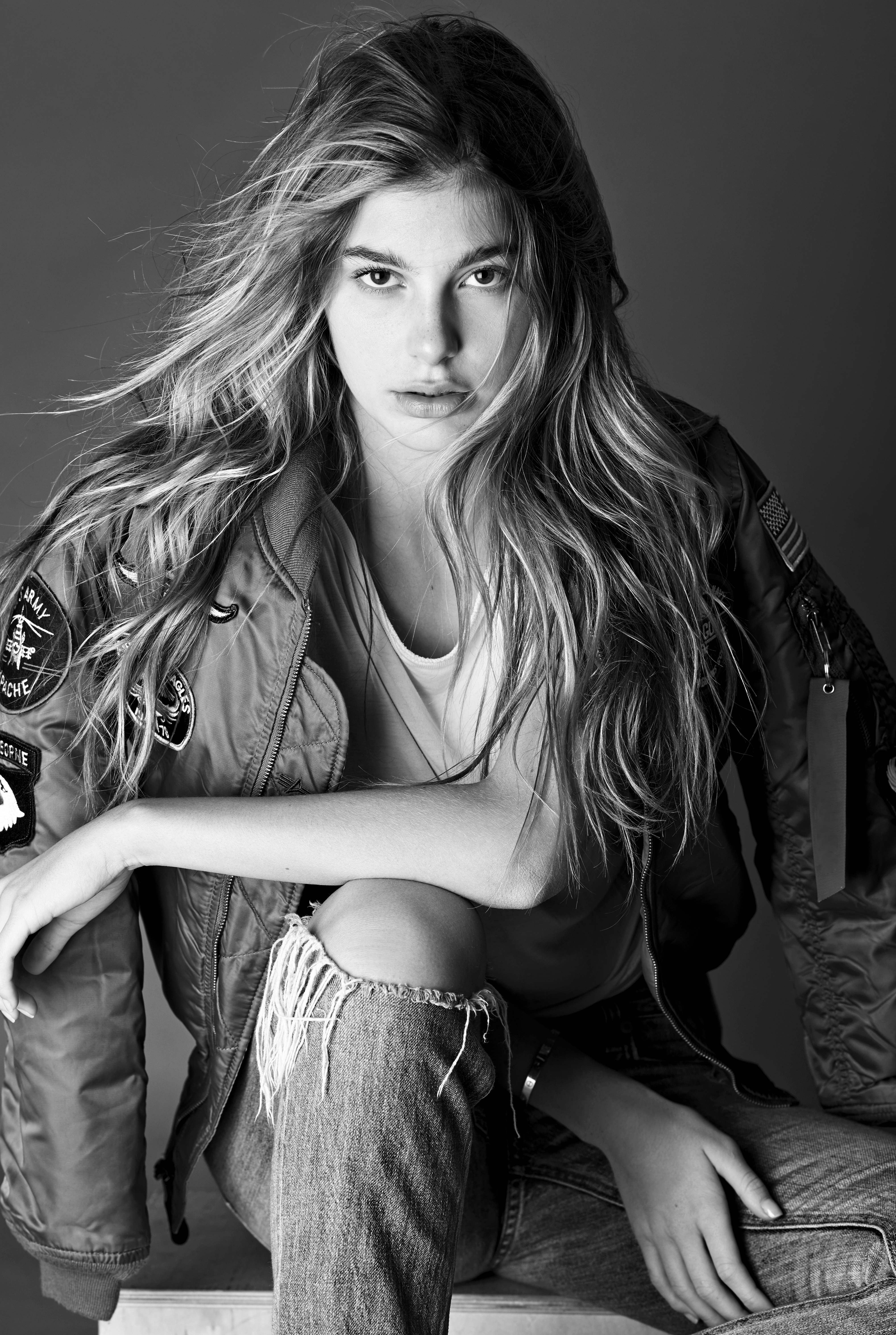 People 4016x5981 Camila Morrone women actress brunette monochrome torn jeans looking at viewer jacket long hair sitting open jacket studio indoors