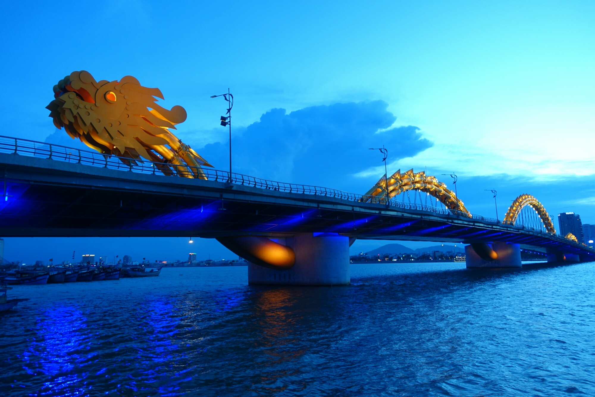 General 2000x1333 architecture bridge water river dragon Danang Vietnam clouds boat lights evening cityscape Asia Chinese dragon blue