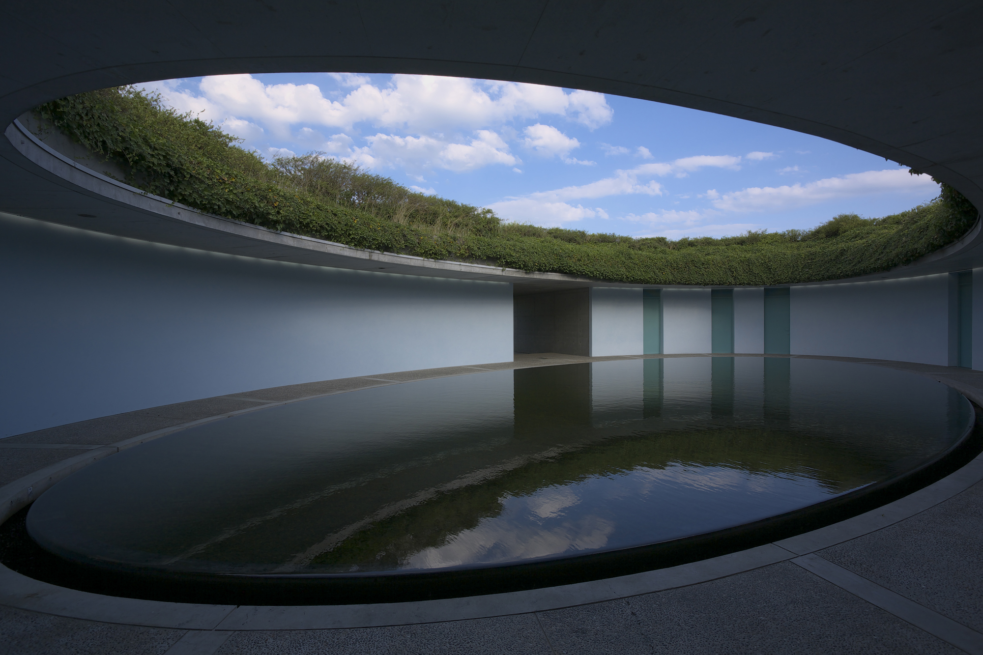 General 2000x1333 architecture modern building clouds water ellipses plants Japan hotel reflection concrete