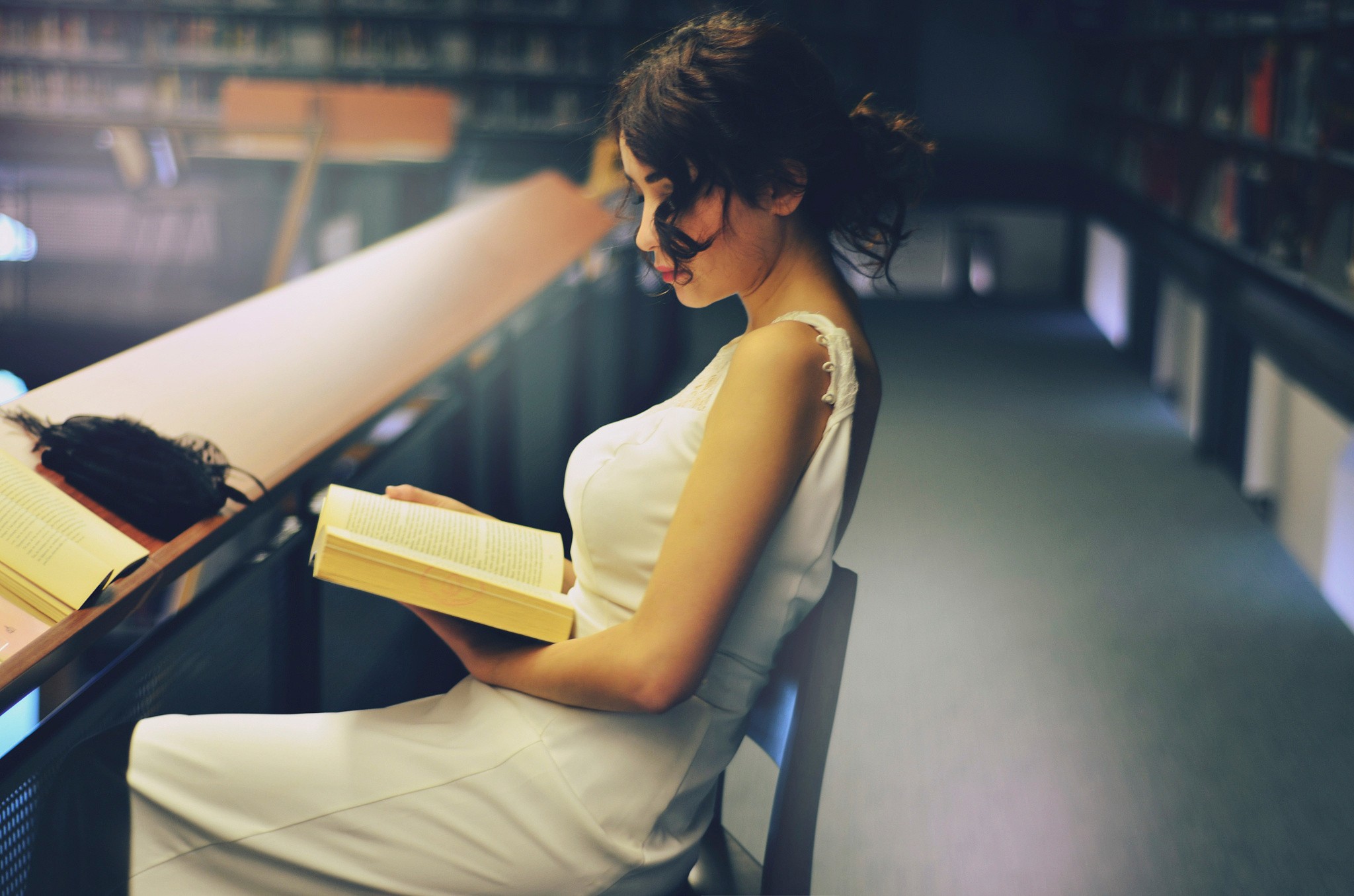 People 2048x1356 women brunette white dress sitting reading books hair in face women indoors indoors library white clothing dress model
