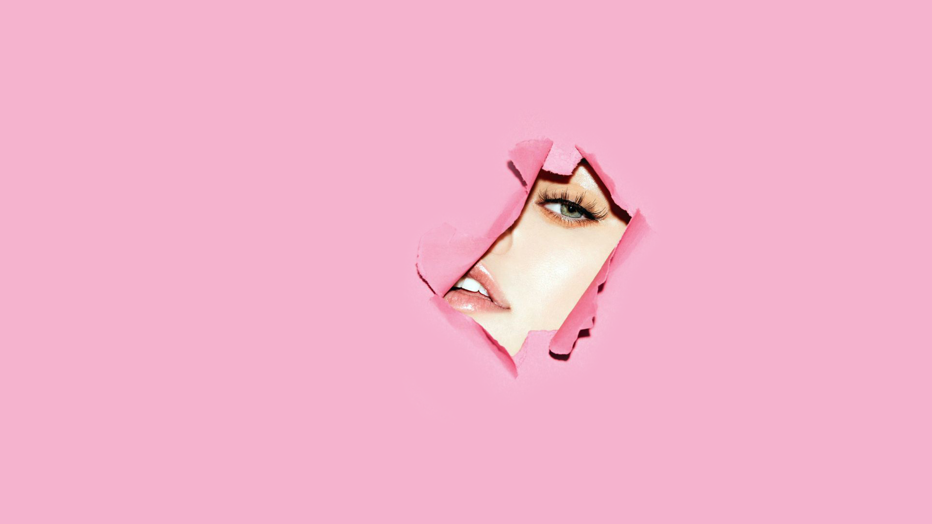 General 1920x1080 simple background face minimalism women one eye closed parted lips pink background teeth green eyes lip gloss eyelashes