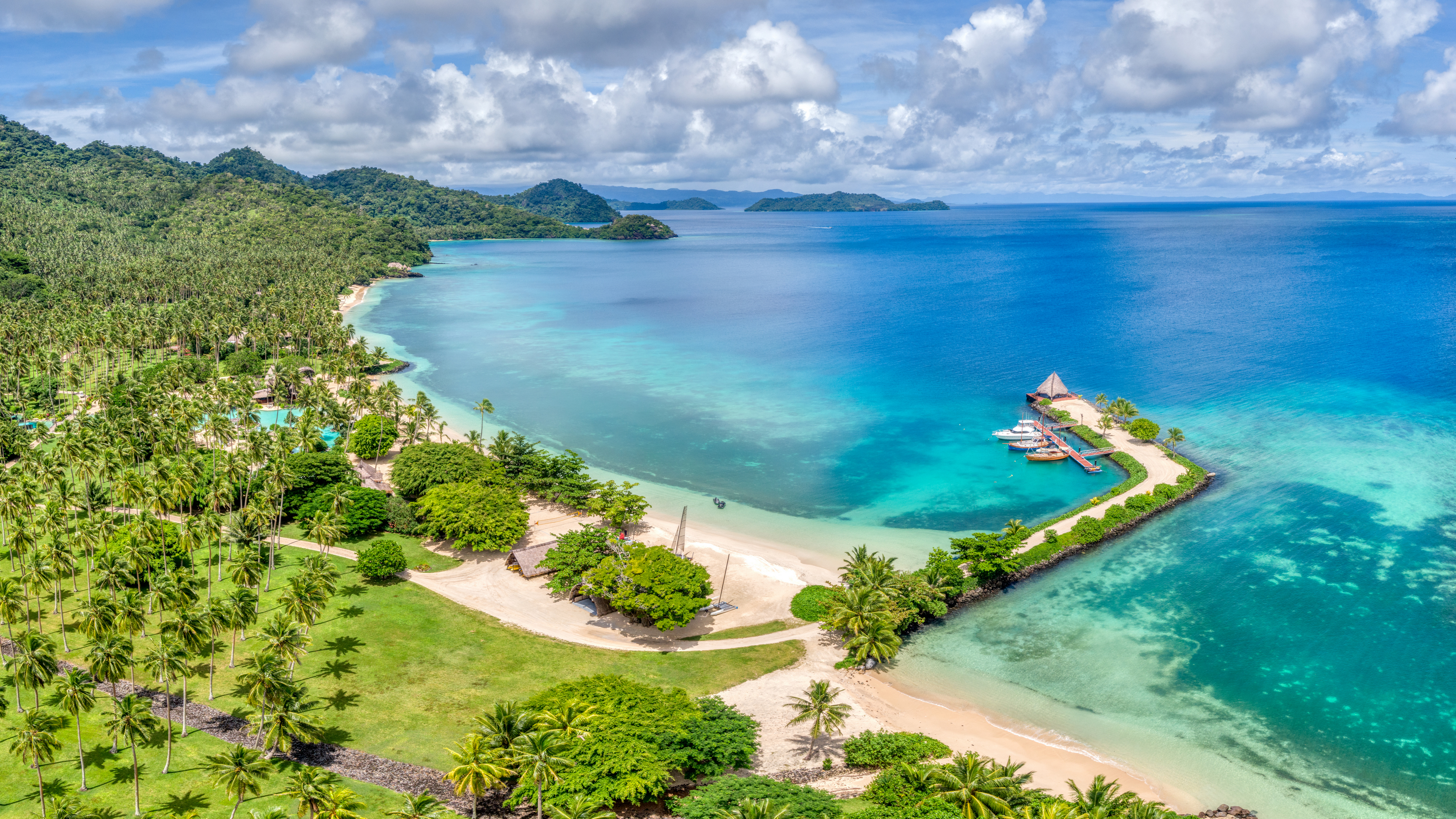 General 3840x2160 photography Trey Ratcliff landscape Fiji bay beach resort water nature forest palm trees hills dock sky clouds bungalow boat grass sand island 4K