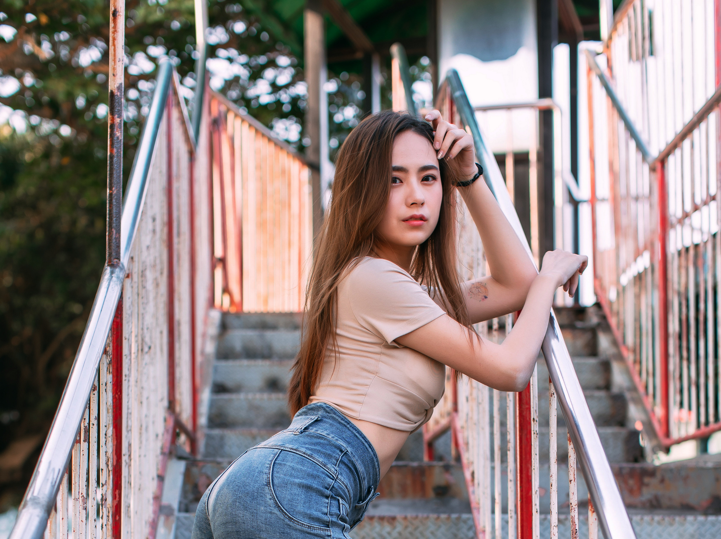 People 2507x1875 Asian model women long hair brunette stairs railing leaning jeans short tops tattoo depth of field trees bracelets passage looking at viewer