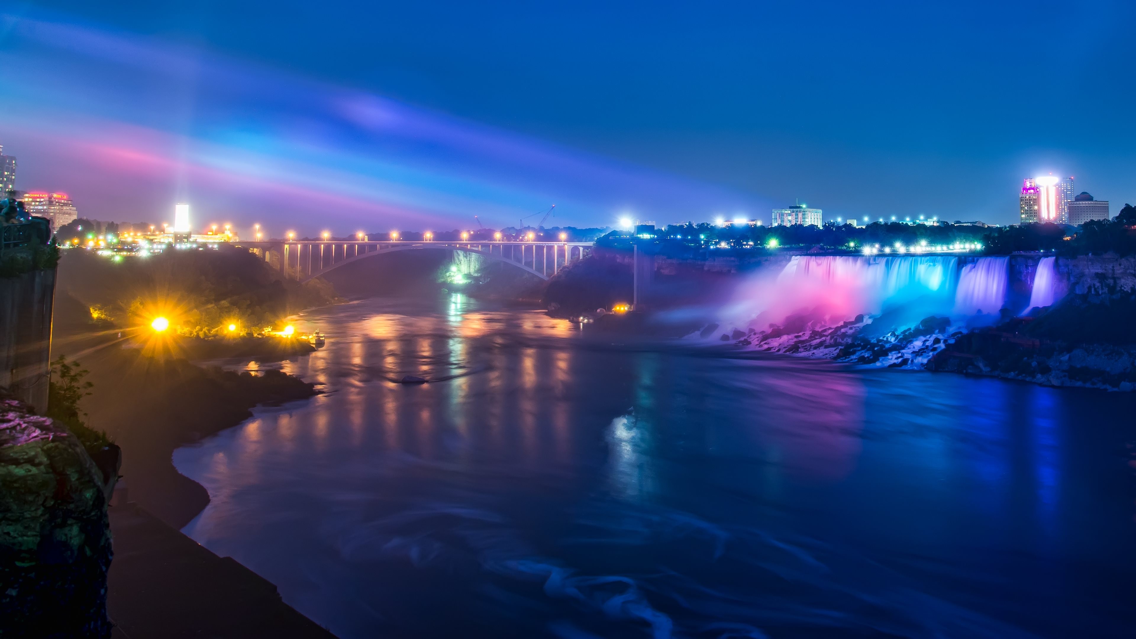 General 3840x2160 Niagara Falls waterfall river lights landscape glowing night bridge neon cyan pink blue city lights motion blur colorful low light