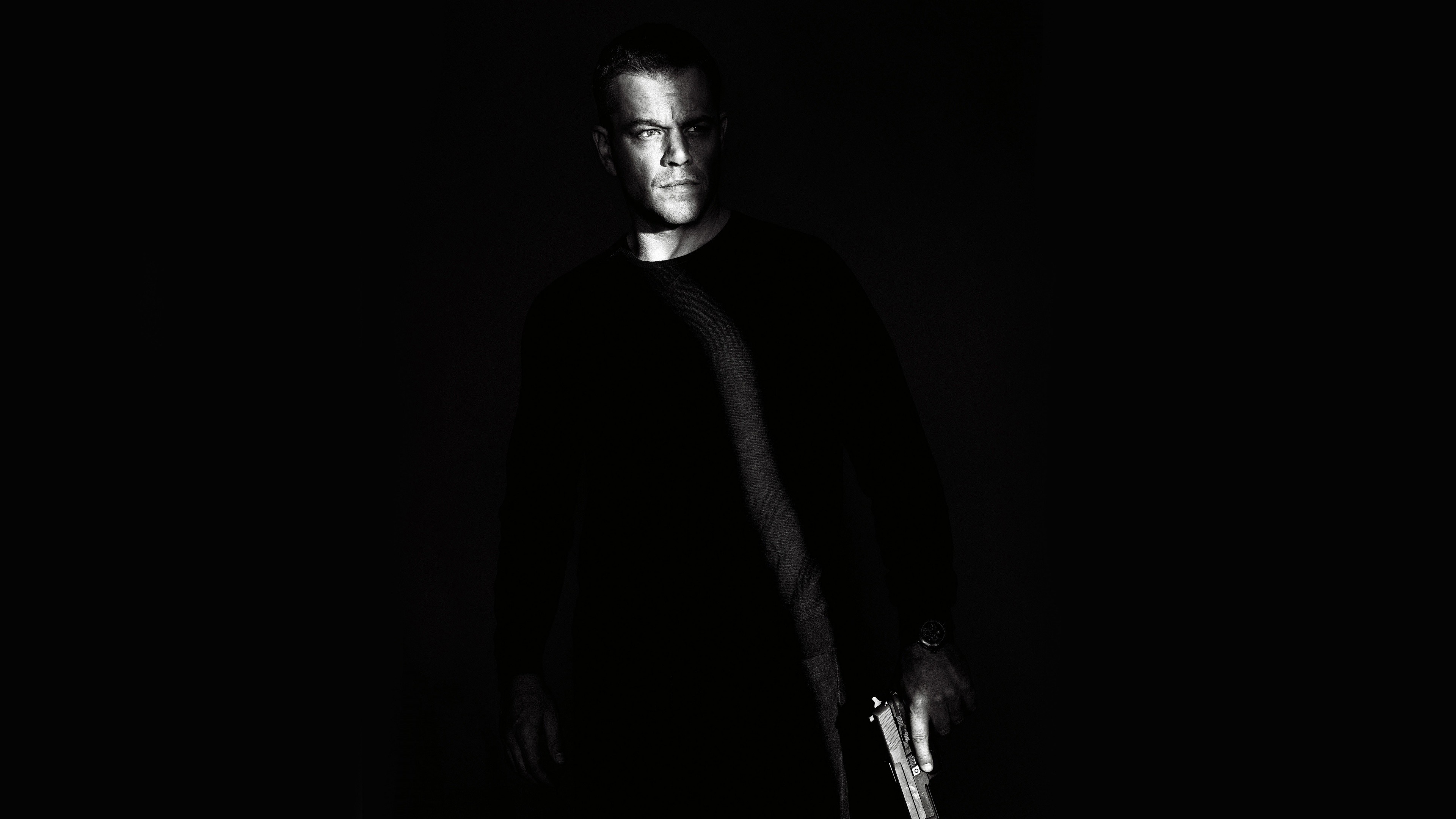 People 3840x2160 movies celebrity Matt Damon Jason Bourne black monochrome gun weapon dark background men