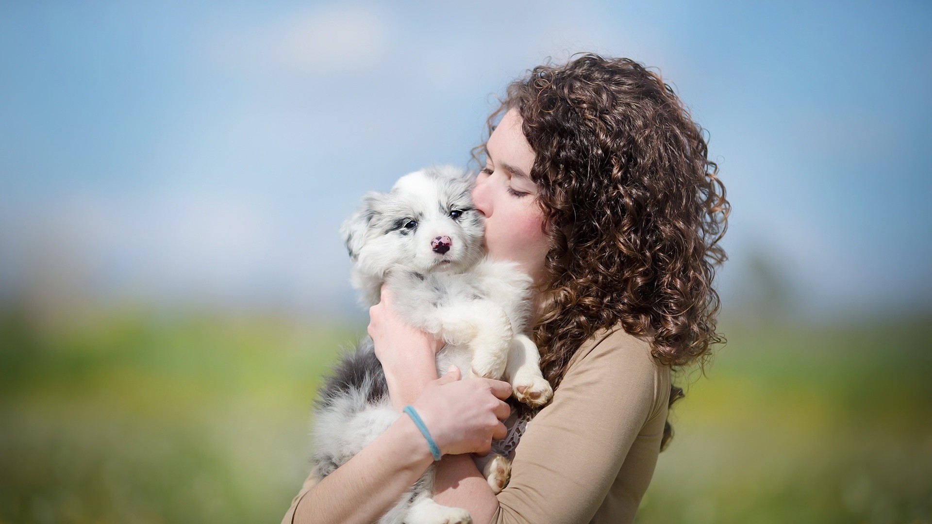 People 1920x1080 women model brunette long hair women outdoors depth of field curly hair animals baby animals dog closed eyes pet