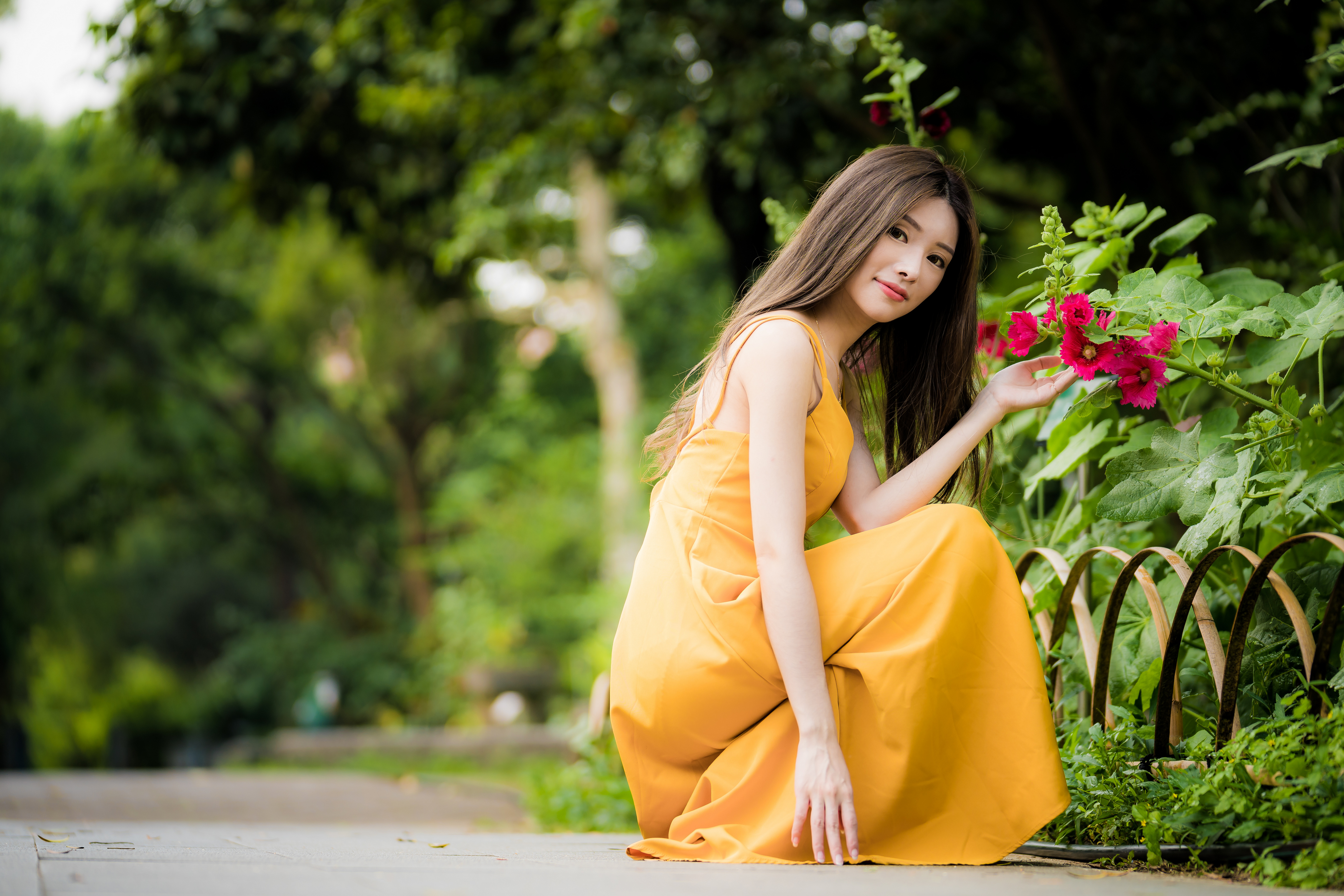 People 4562x3043 Asian women model long hair brunette depth of field yellow dress flowers trees squatting looking at viewer
