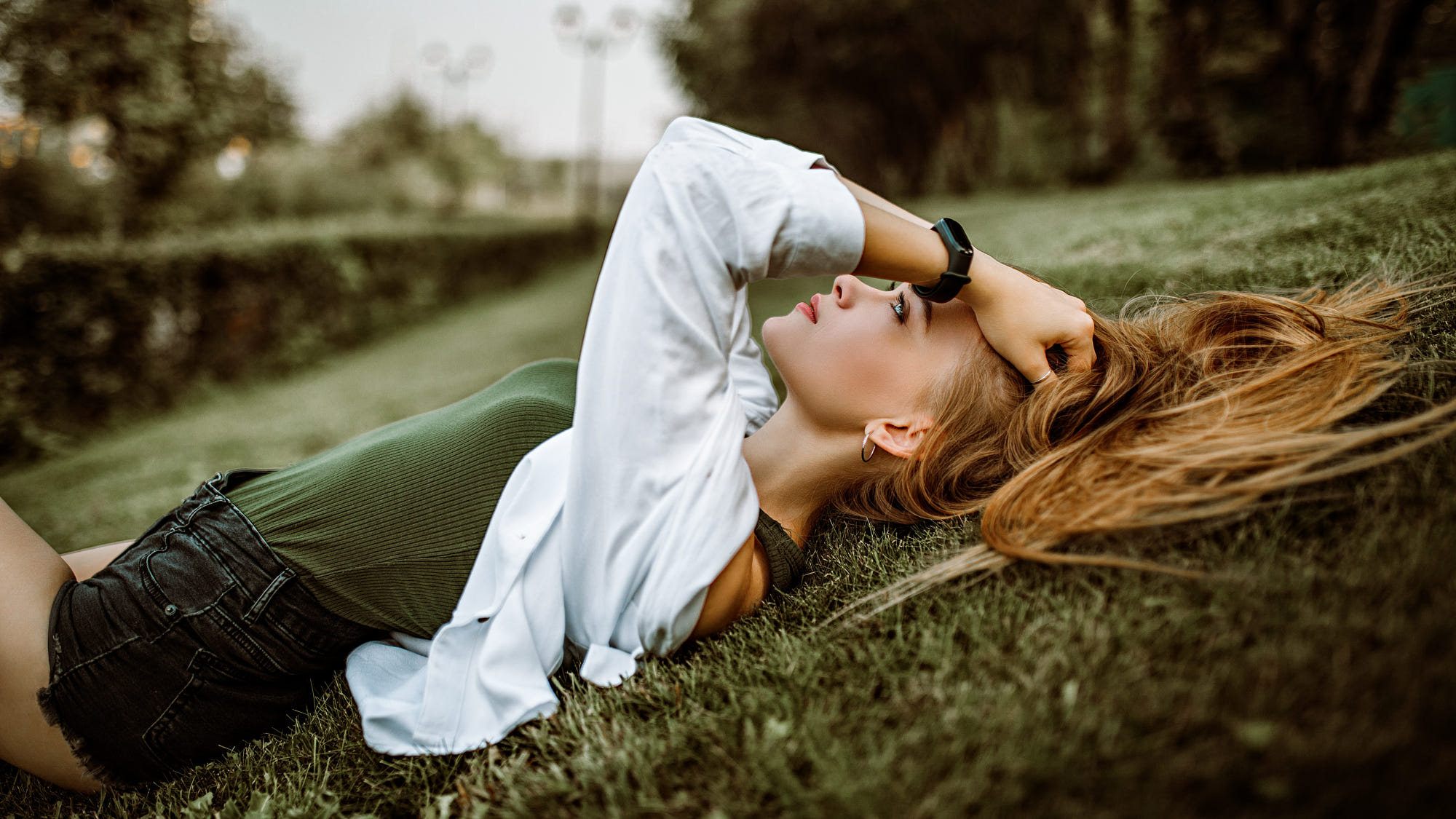 People 2000x1125 women outdoors blonde profile lying on back grass hand(s) on head high waisted shorts bokeh portrait on the floor depth of field women jean shorts bodysuit