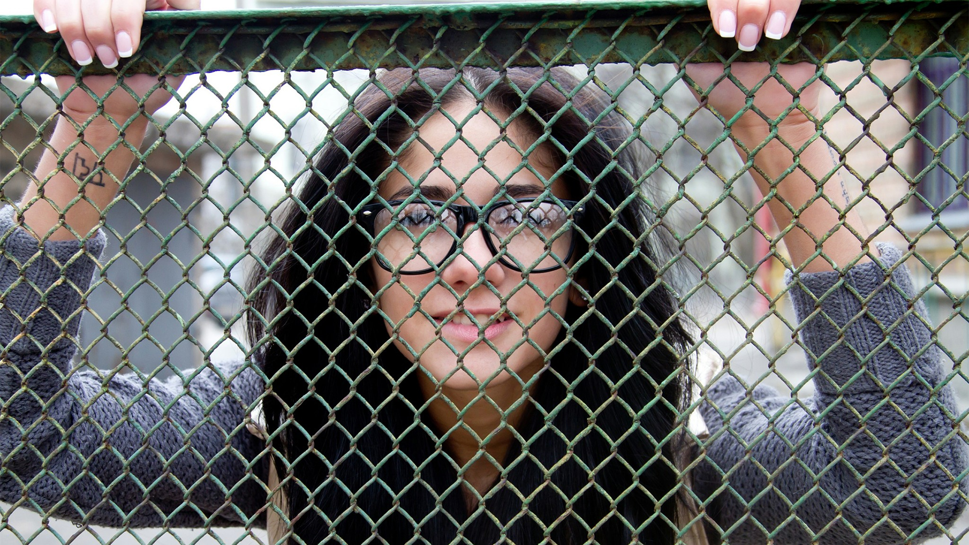 People 1920x1080 women model Malina A black hair glasses biting lips chain-link fence fence sweater closeup