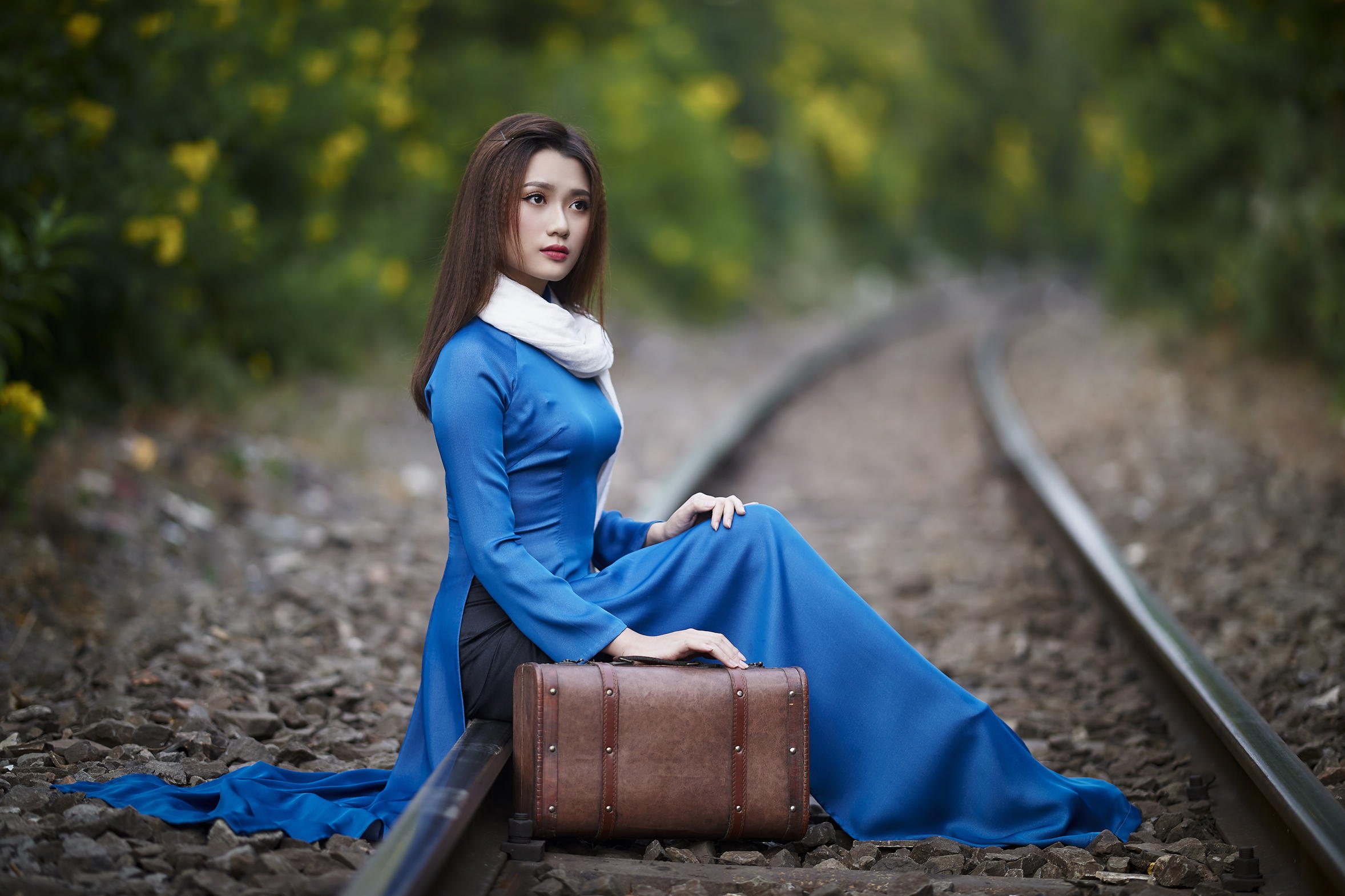 People 2356x1570 Asian model women long hair dark hair depth of field women outdoors sitting railway suitcase blue dress white scarf hairpins