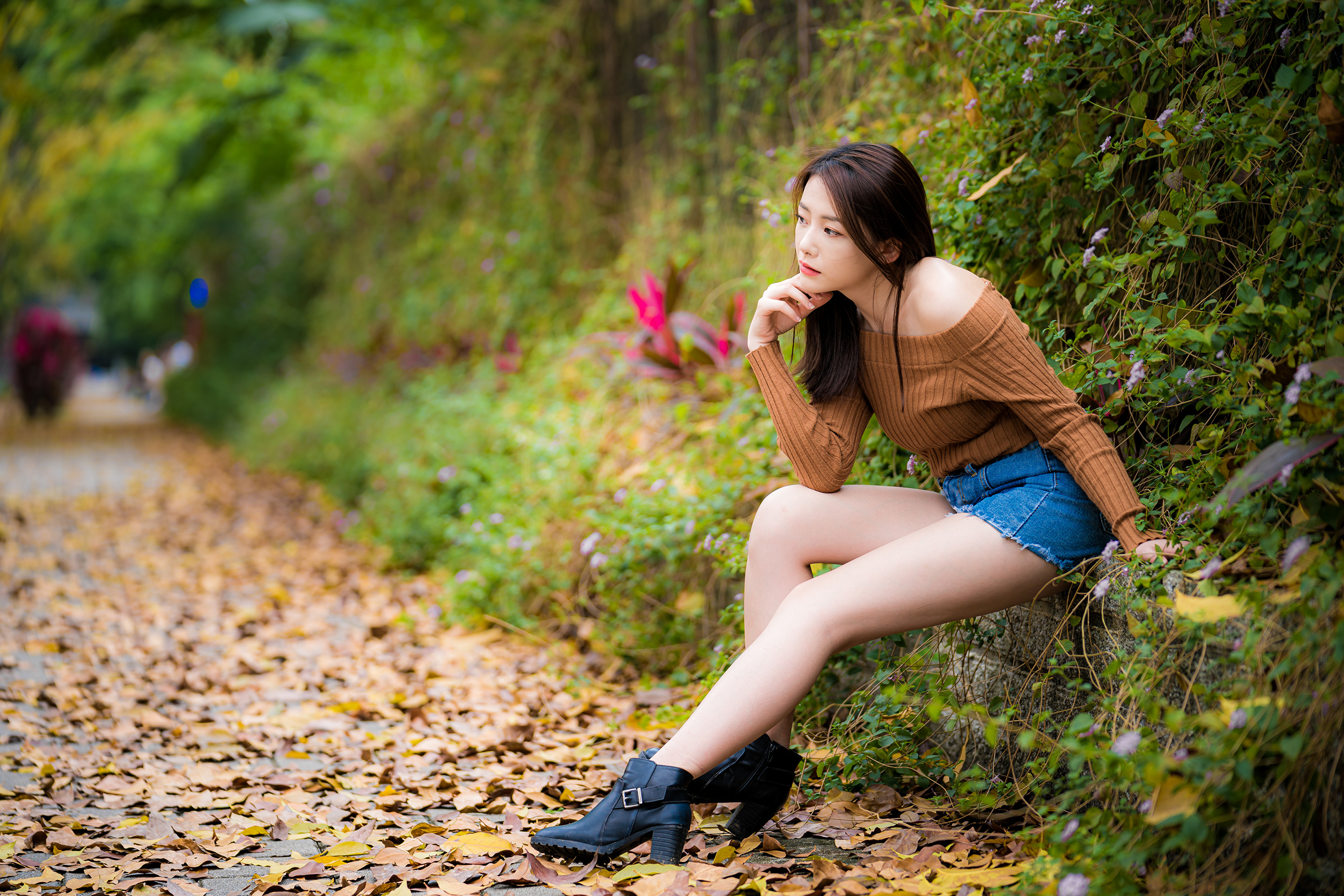 People 3840x2561 Asian model women long hair dark hair depth of field sitting leaves bushes trees flowers plants pullover bare shoulders jean shorts boots
