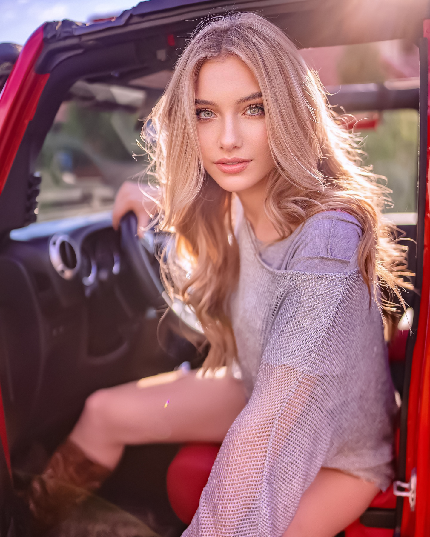 People 1440x1799 Sagaj Photography women Alexandra Lenarchyk blonde long hair wavy hair purple clothing blue eyes looking at viewer car interior car red sunlight sun rays brown boots sitting in the car Jeep cowboy boots model women outdoors