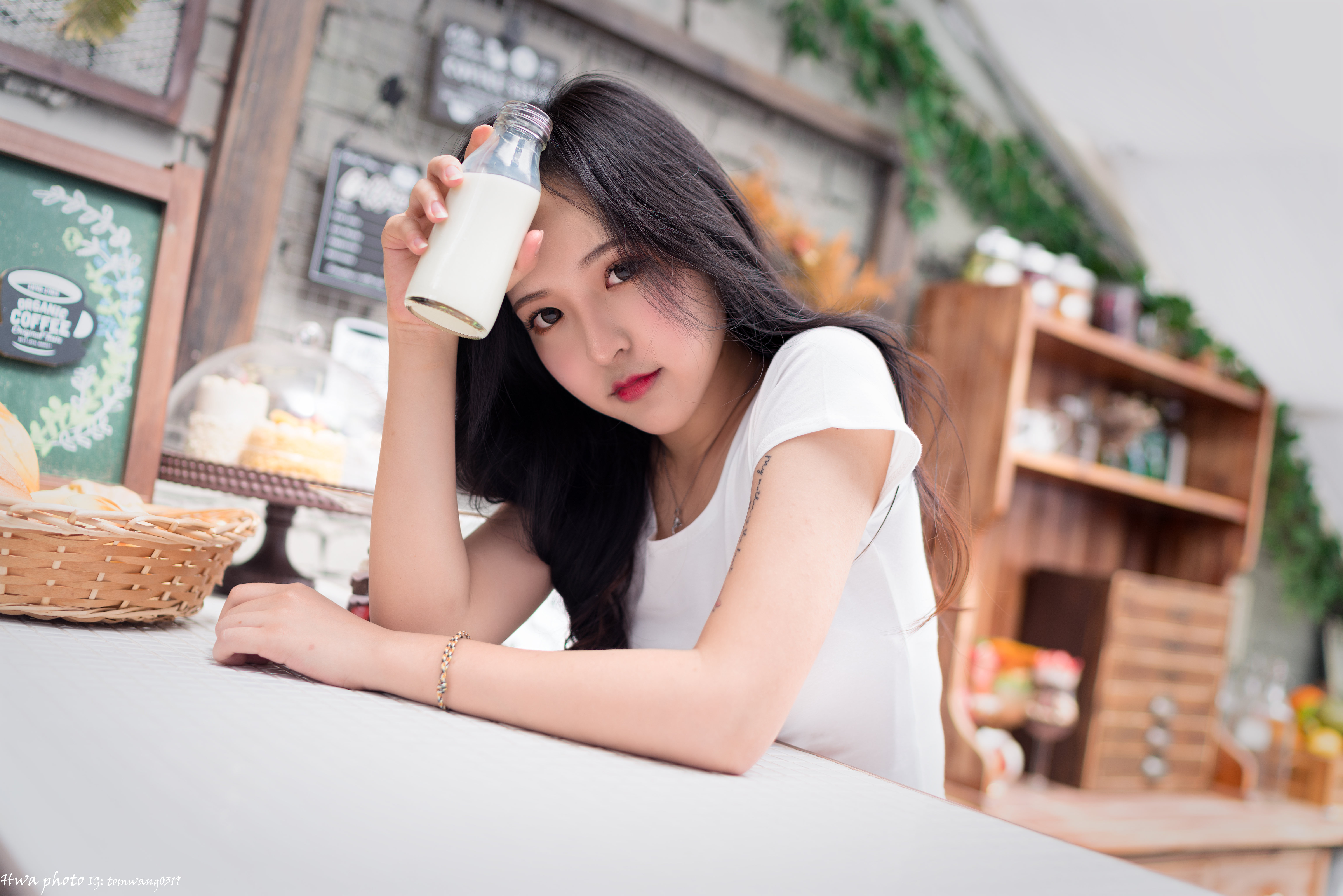People 6144x4098 Asian model women long hair brunette sitting milk T-shirt table cupboard bracelets cake signs