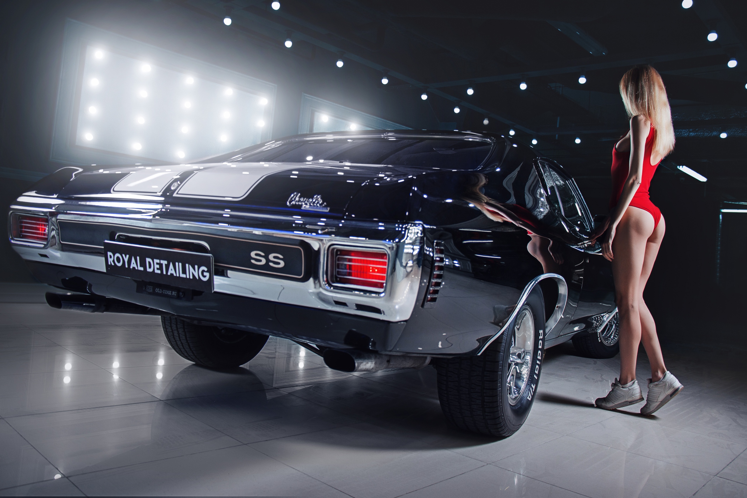 People 2560x1707 women model blonde bodysuit ass car women with cars Chevelle SS muscle cars racing stripes rear view standing Chevrolet Chevelle sneakers American cars taillights lights floor long hair vehicle licence plates reflection