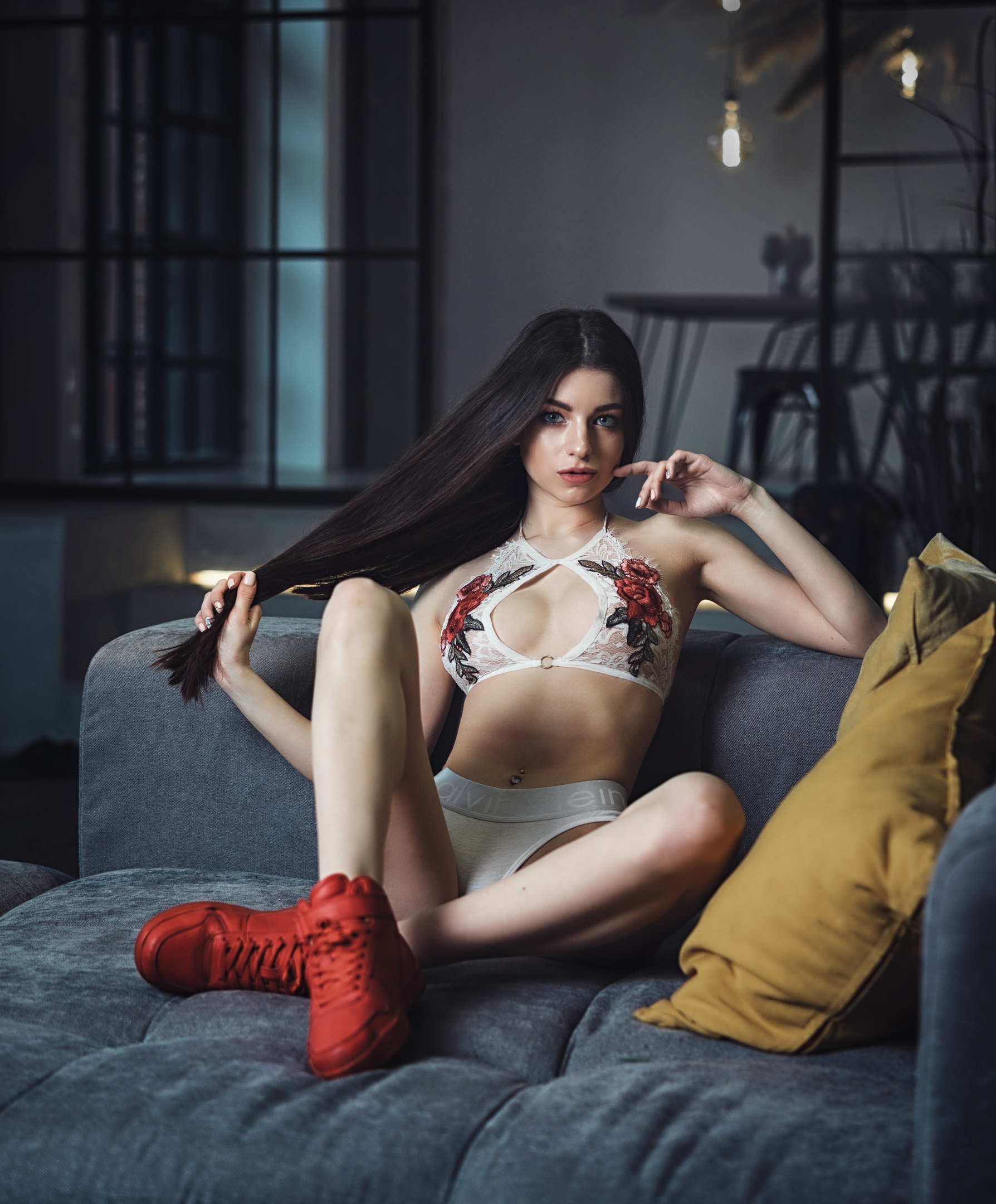 People 1788x2160 Anna Sazonova women model brunette long hair looking at viewer holding hair hair pulling lingerie bra cleavage panties Calvin Klein sneakers sitting couch cushions bokeh depth of field touching face indoors women indoors Russian women Russian gray eyes red shoes