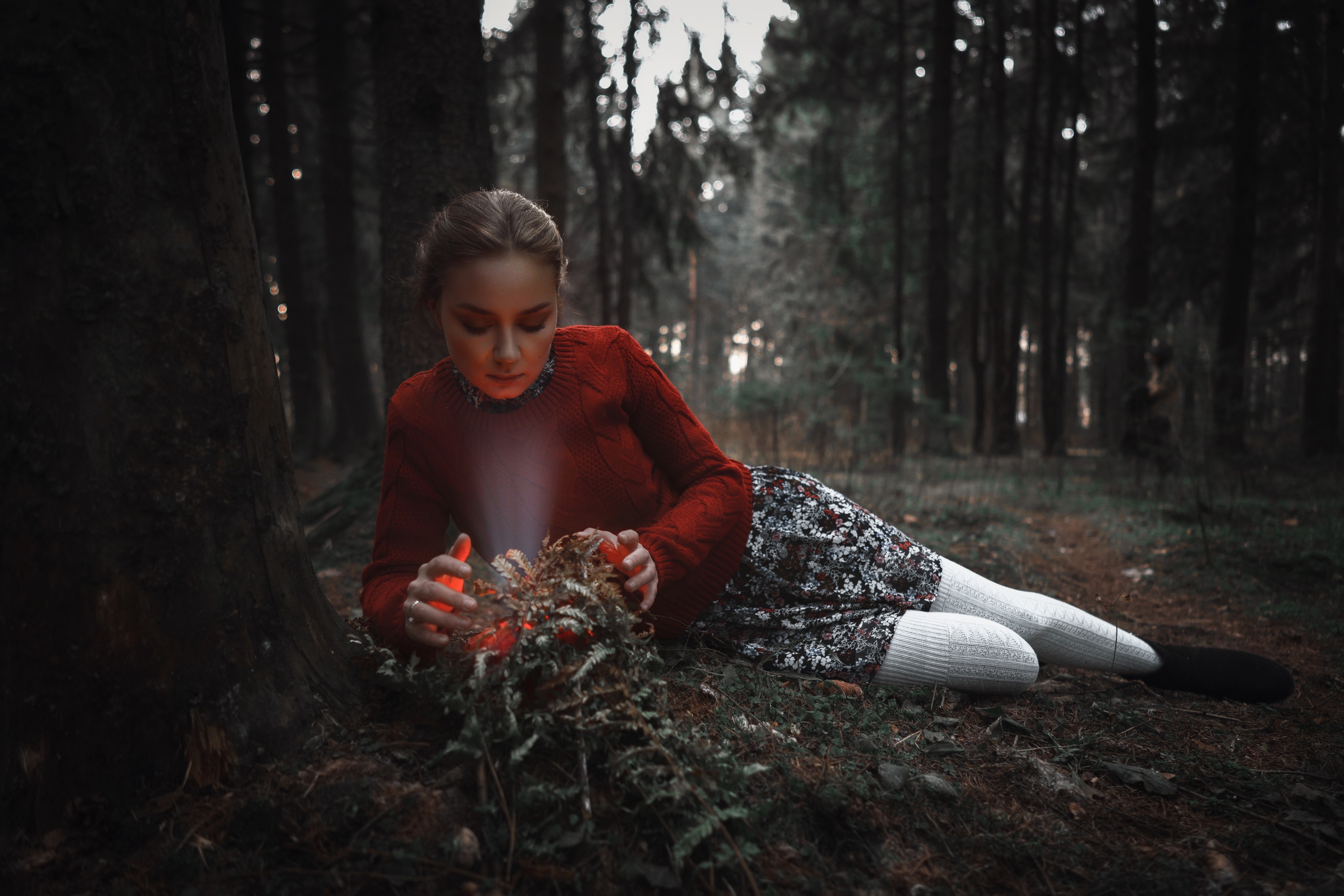 People 2560x1707 women model forest trees women outdoors sweater red sweater looking below skirt black boots socks white socks thigh high socks ankle boots long sleeves depth of field low light