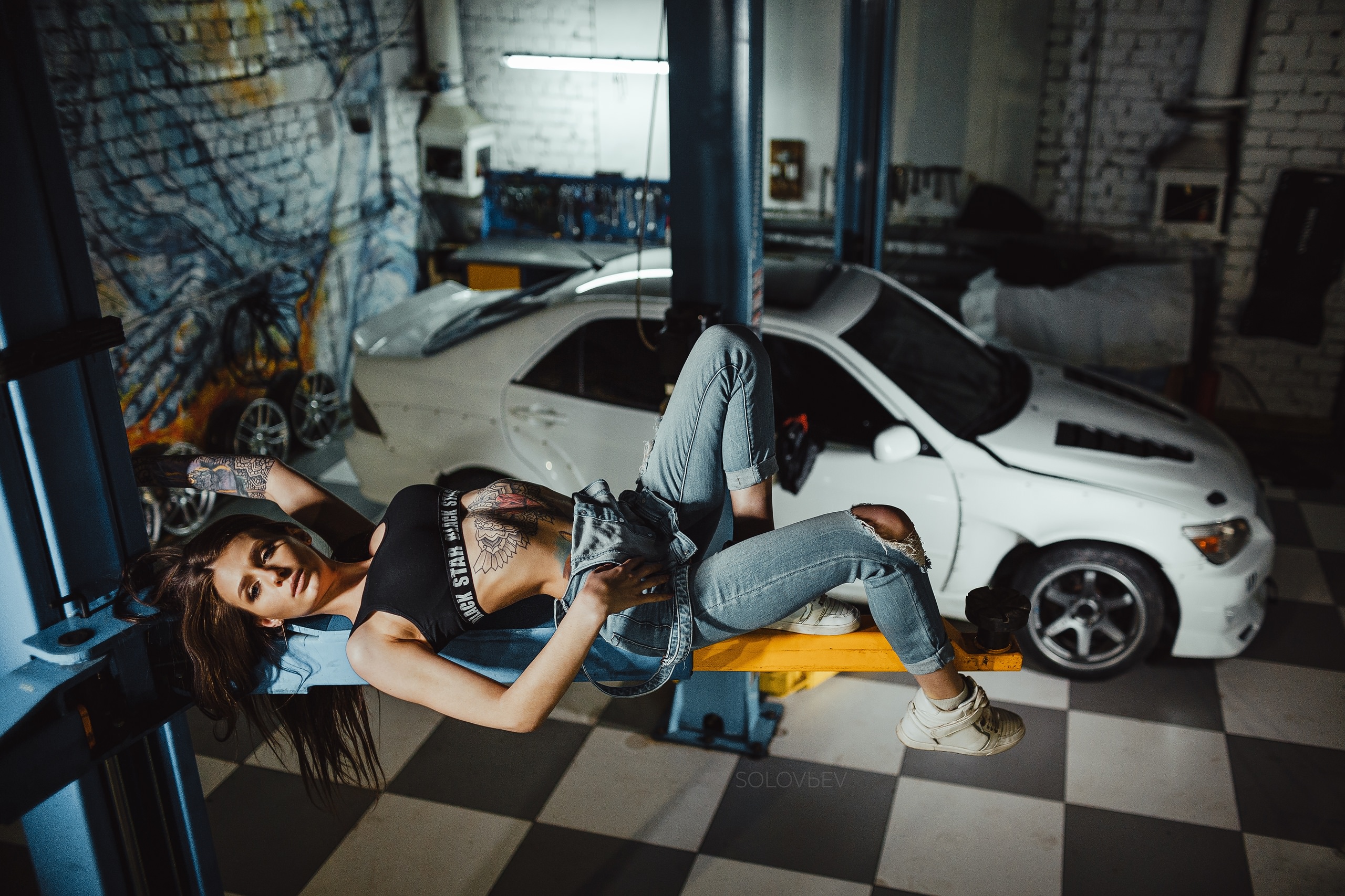 People 2560x1707 women Artem SolovЬev garage women with cars overalls torn clothes ribs black top sneakers white sneakers socks white socks short socks bare midriff brunette arched back car