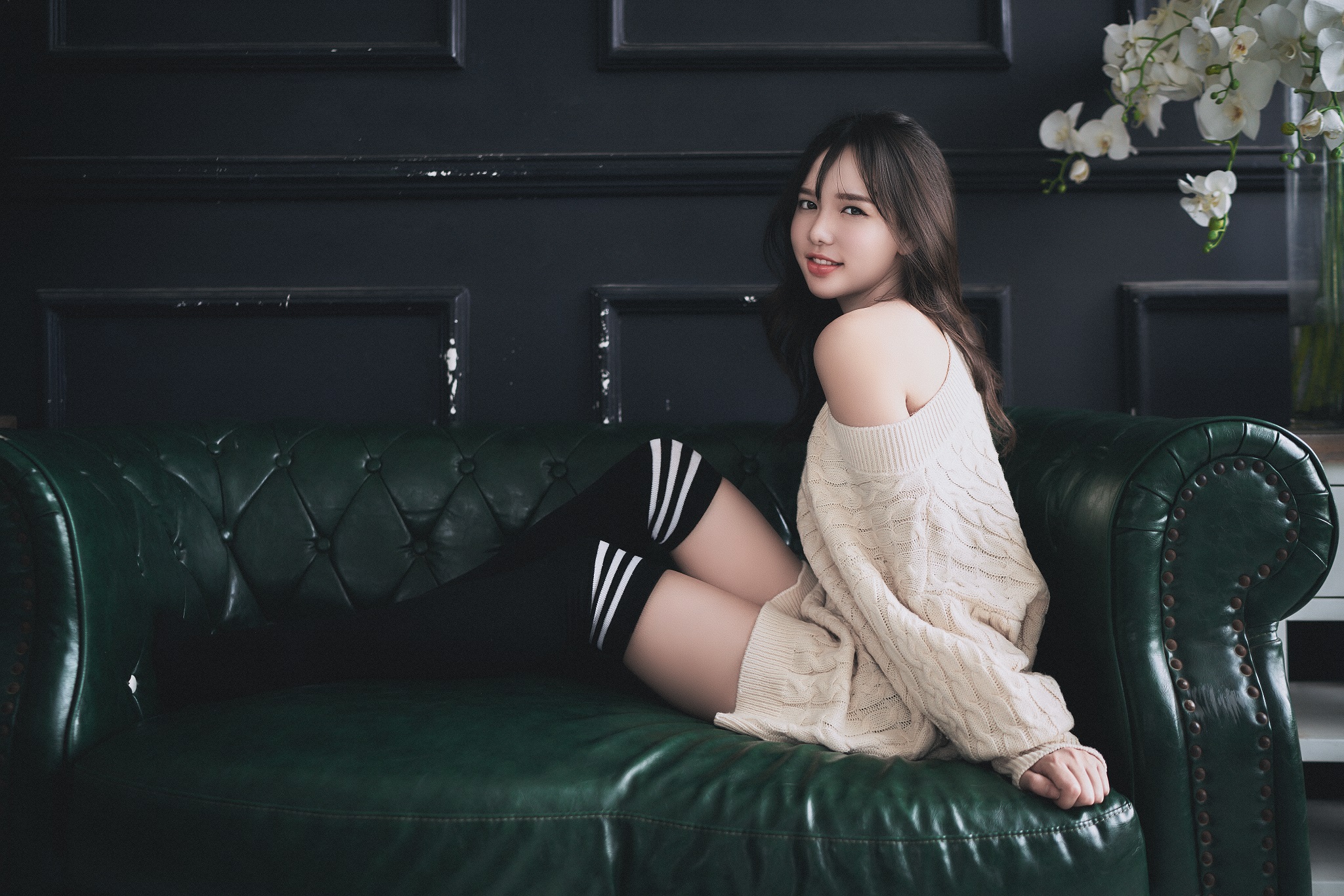 People 2048x1365 women model Asian brunette looking at viewer knee-highs sweater sitting couch bare shoulders women indoors long hair white flowers zettai ryouiki