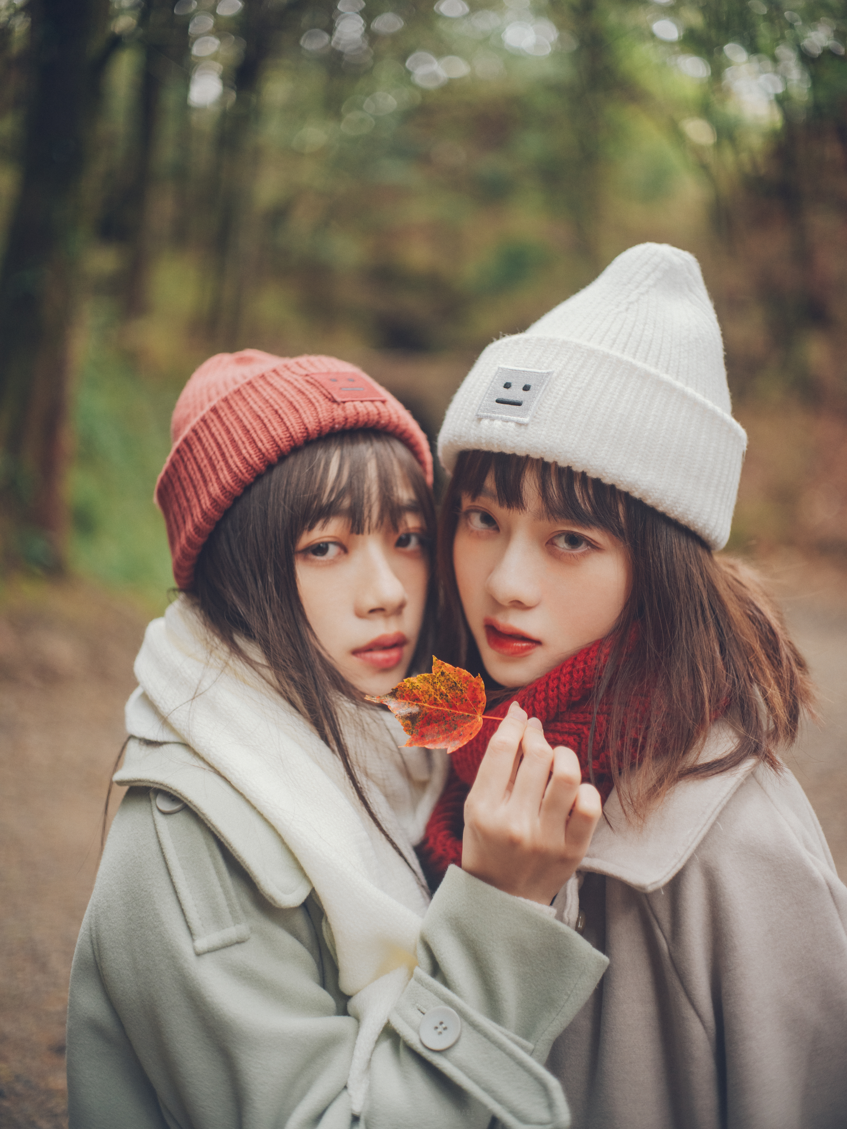 People 2880x3840 Asian two women women outdoors looking at viewer hat women with hats makeup red lipstick leaves brunette outdoors women