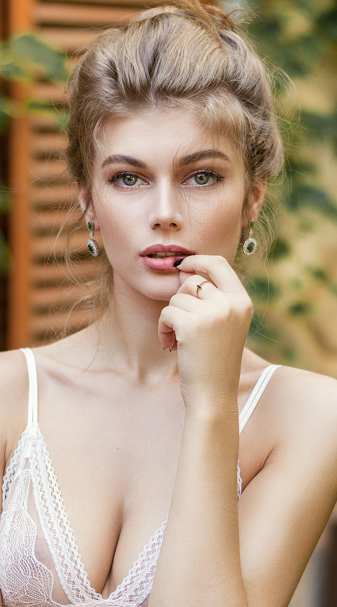 People 1110x2000 Alexandru Zdrobău model women portrait display finger on lips white bra cleavage women outdoors looking at viewer green eyes long earrings Dorina Darii face black nails painted nails parted lips