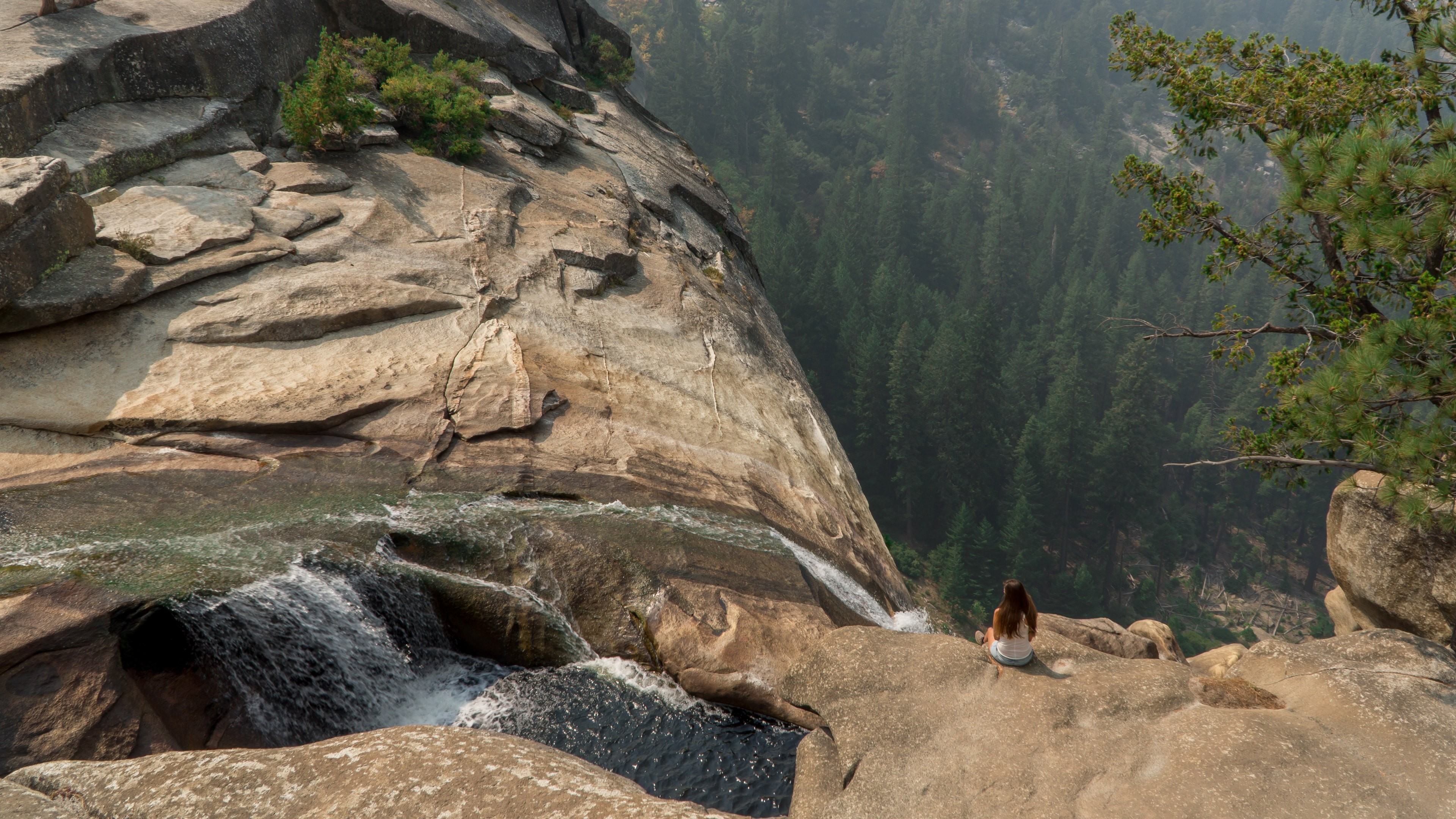 General 3840x2160 Yosemite Valley waterfall nature landscape looking into the distance USA women outdoors sitting brunette long hair rocks California women model