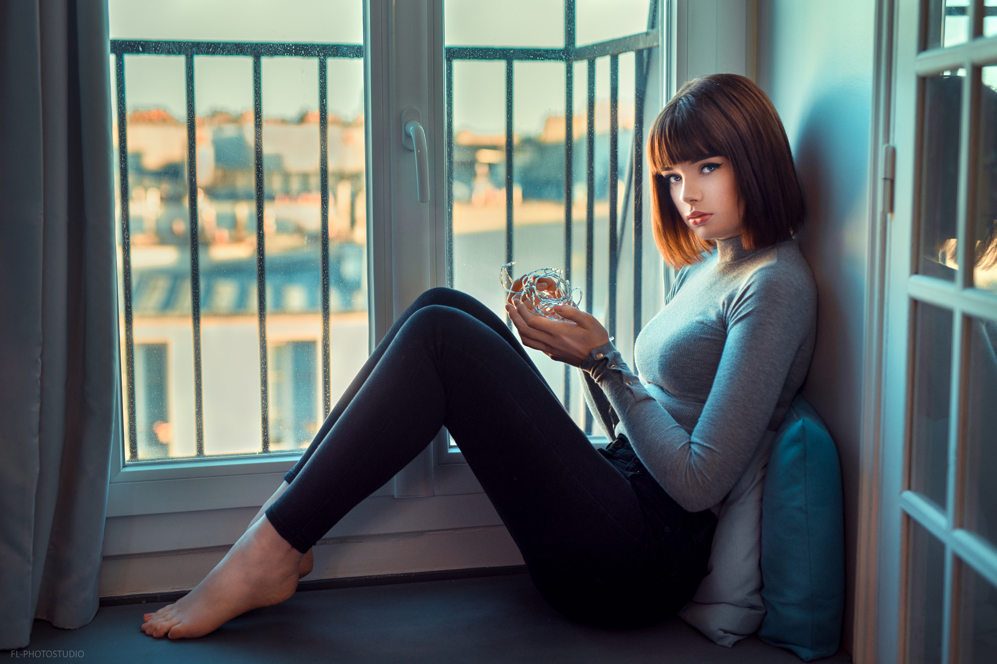 People 2048x1365 Marie Grippon women Lods Franck portrait sitting window eyeliner pillow barefoot short hair grey sweater black pants looking at viewer legs together by the window tight clothing model