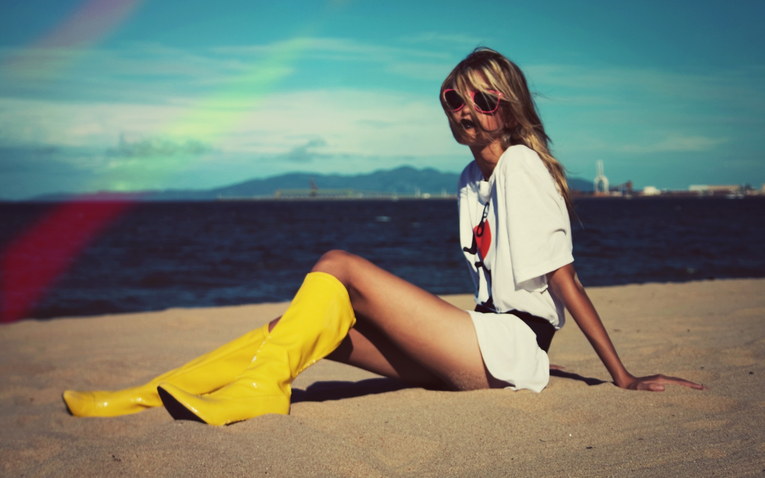 People 2560x1600 beach blonde women outdoors model women outdoors Yellow Shoes boots sand covered sunglasses women with shades hair in face T-shirt white tops