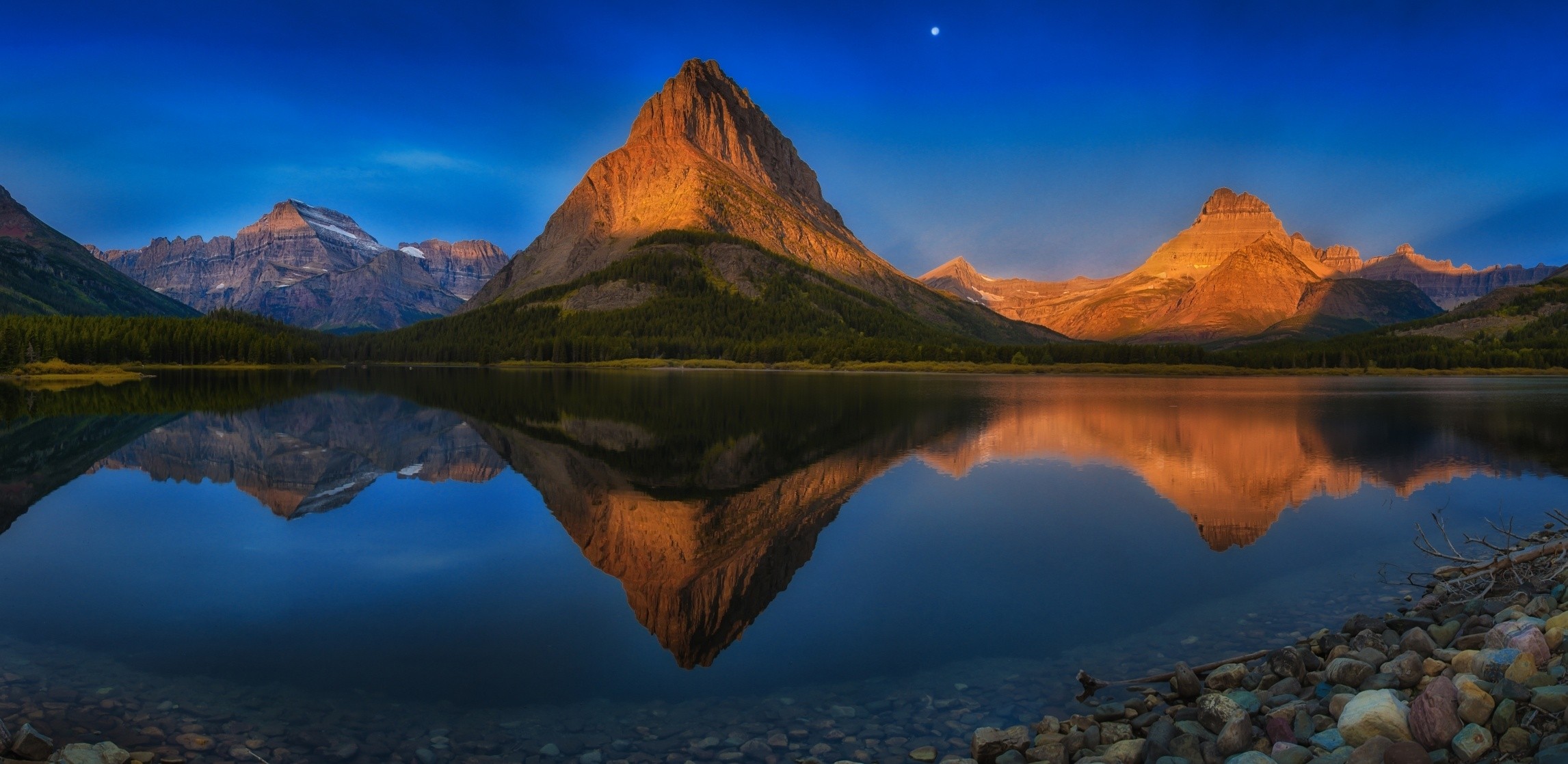 General 2293x1118 lake mountains reflection Moon forest summer blue water stones Glacier National Park Montana nature landscape sunset 4K USA Swiftcurrent Lake