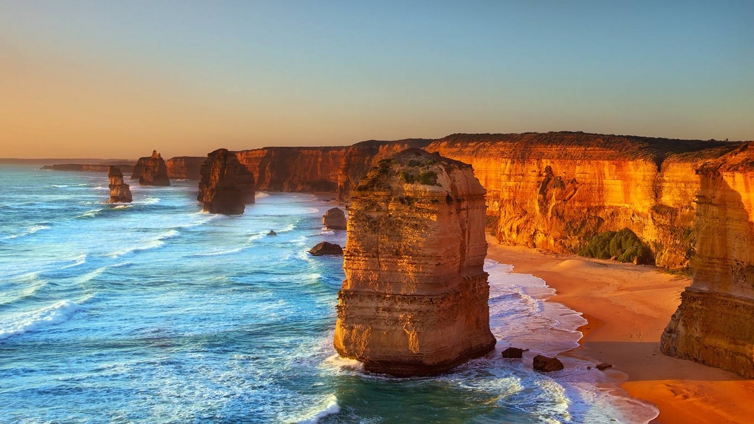 General 1500x843 Australia beach limestone rocks Twelve Apostles sea cliff sand coast waves water sunset nature landscape