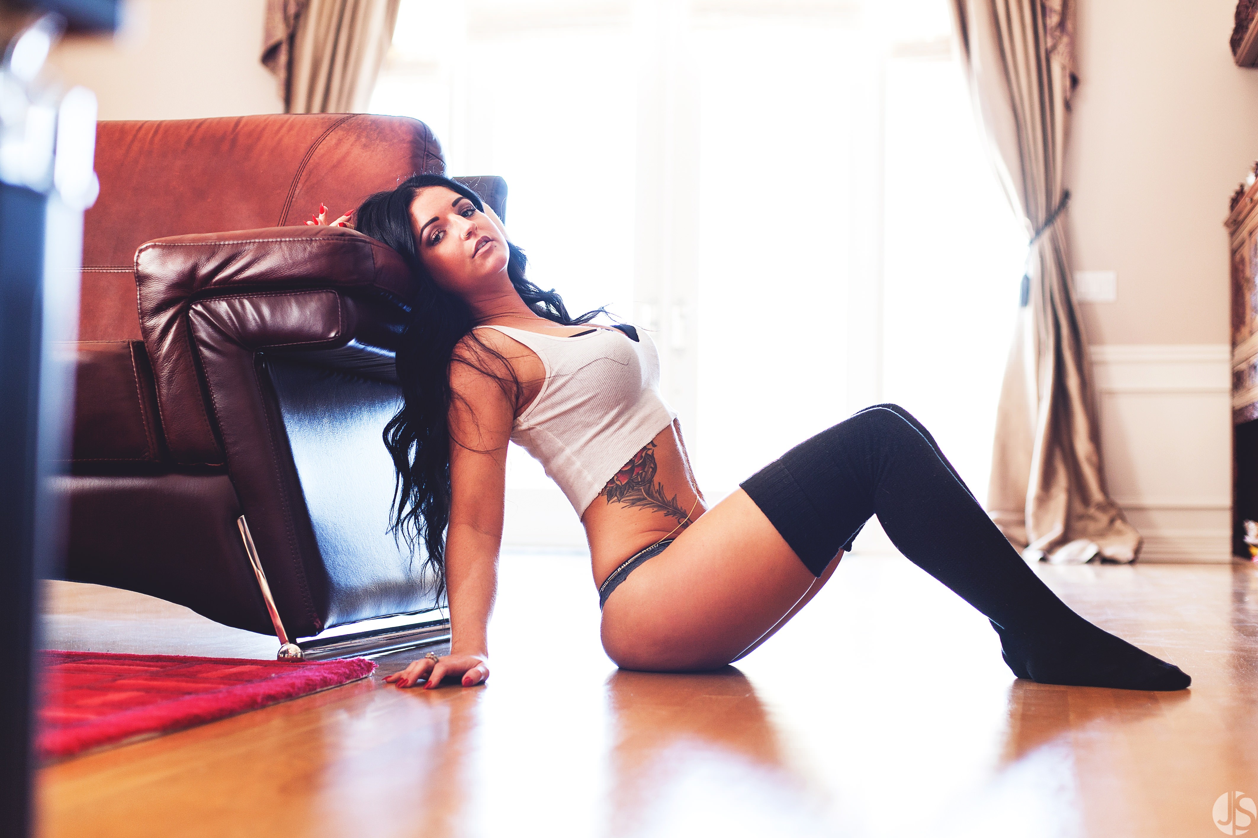 People 4249x2832 women model sitting tattoo white tops curvy socks black socks  thigh high socks bent legs legs together crop top bare midriff watermarked on the floor women indoors inked girls black hair wooden surface overexposed