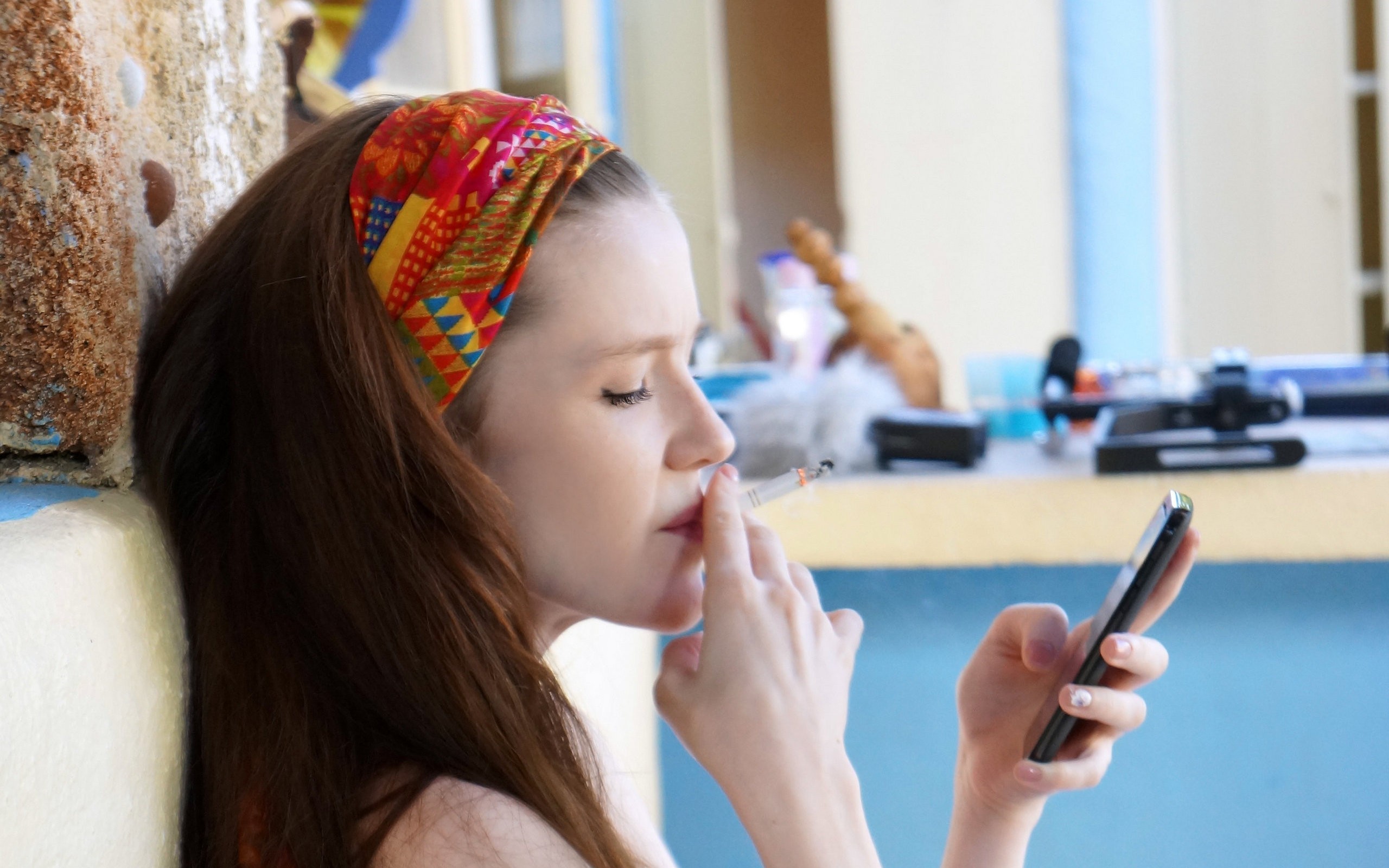 People 2560x1600 women Emily Bloom smoking brunette profile cigarettes Ukrainian women Ukrainian model model face smartphone hairband