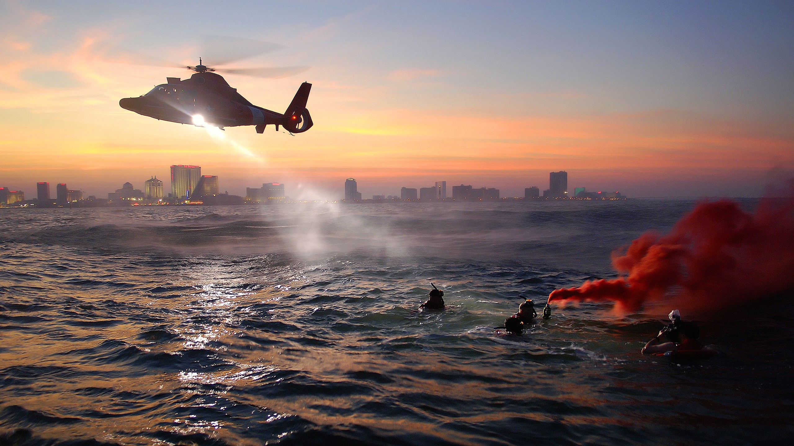 General 2560x1440 military helicopters military aircraft coast guard New York City aircraft sea United States Coast Guard colored smoke military training divers spotlights Rescue Team sunset dusk skyline