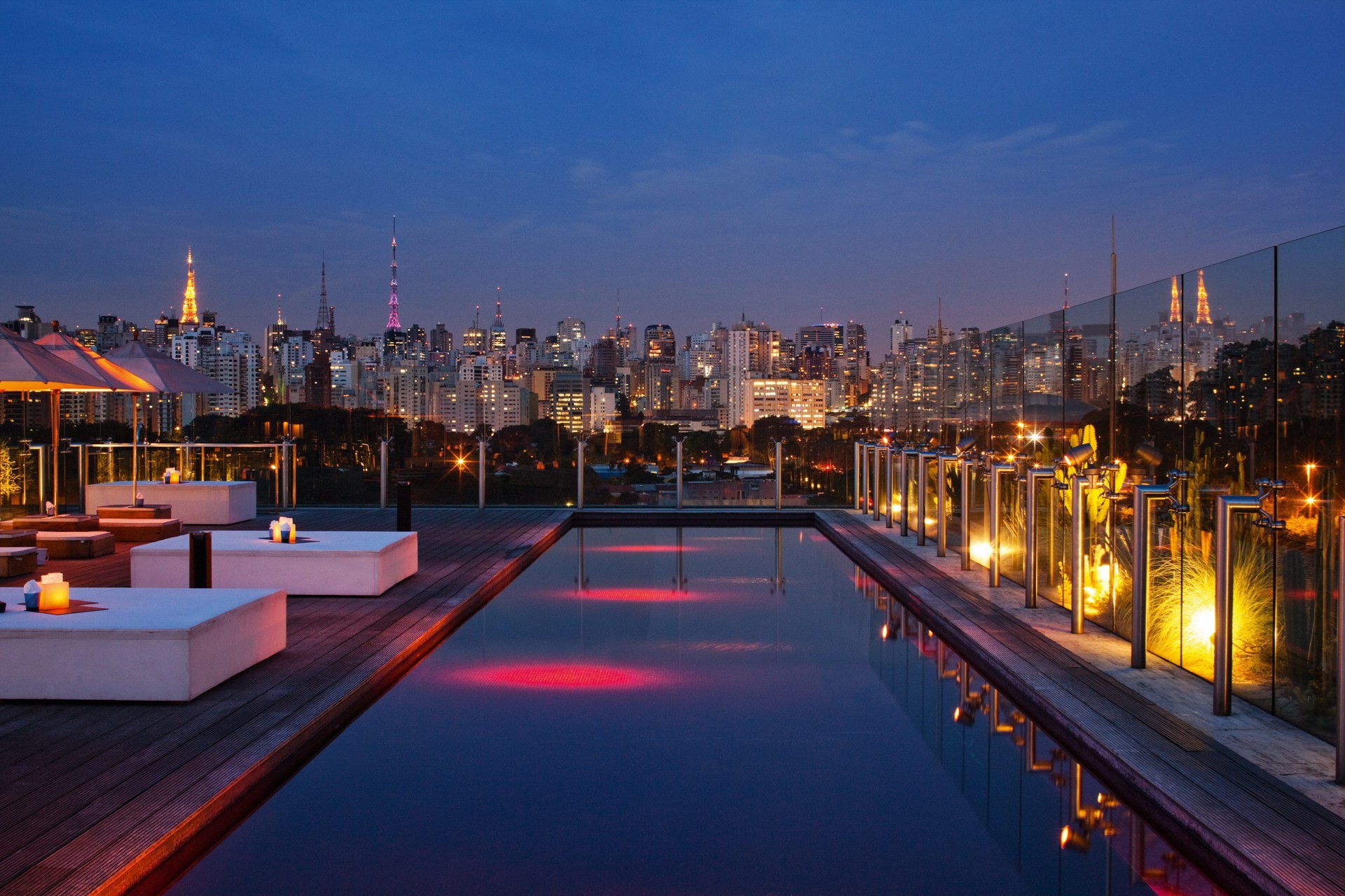 General 1920x1280 cityscape city architecture night building skyscraper lights street light clouds São Paulo swimming pool hotel wooden surface deck chairs table parasol tower reflection luxury Brazil city lights