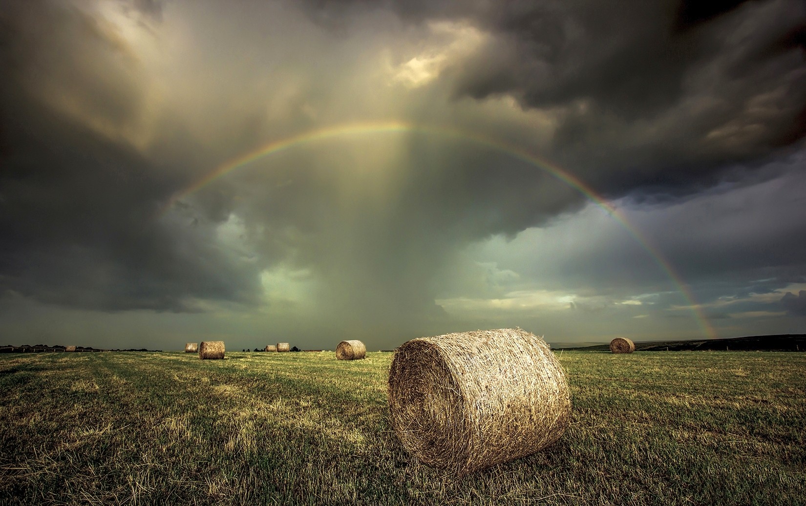 General 1650x1036 rainbows field clouds storm landscape sky hay bales