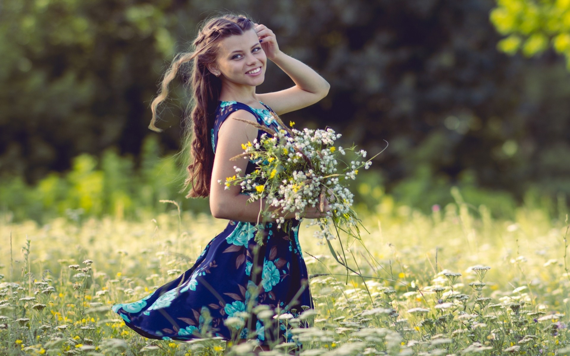 People 1920x1200 women model brunette long hair women outdoors looking at viewer nature field grass flowers depth of field bare shoulders blue dress summer wavy hair windy smiling hands in hair trees parted lips dress blue clothing plants outdoors standing