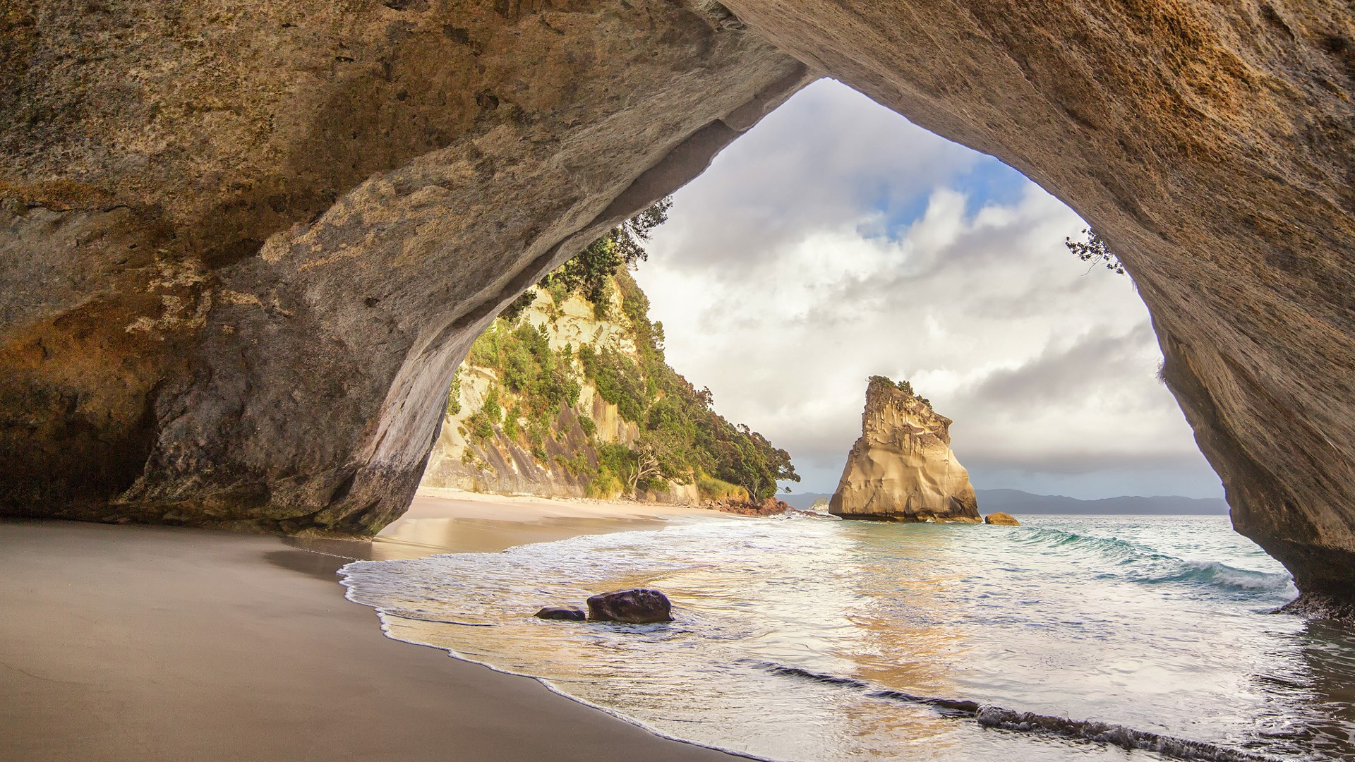 General 1920x1080 New Zealand beach nature sand cave waves clouds calm rock formation