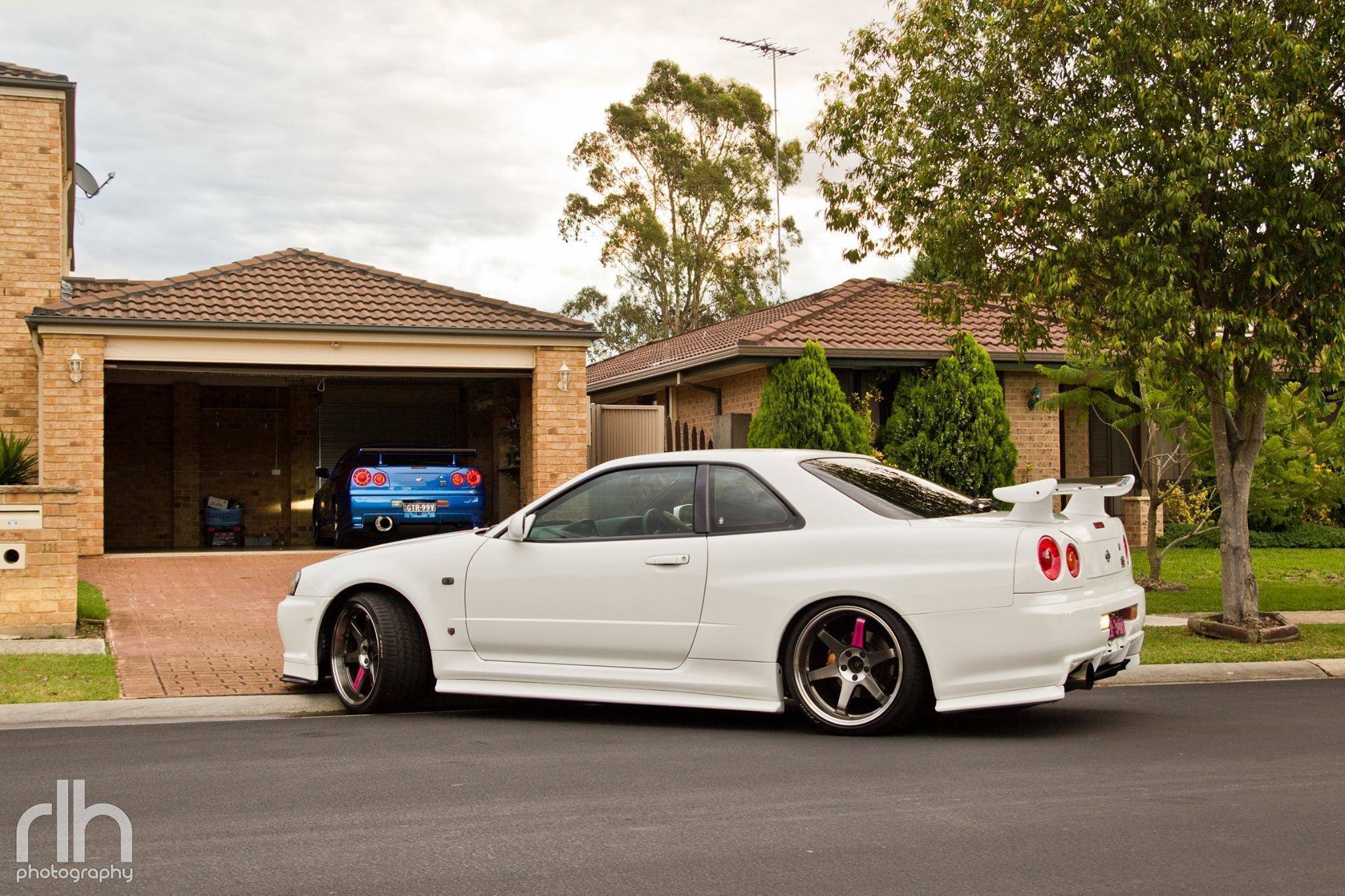 General 2048x1365 Nissan Nissan Skyline R34 garage white cars vehicle Nissan Skyline Japanese cars car side view taillights trees house sky overcast clouds