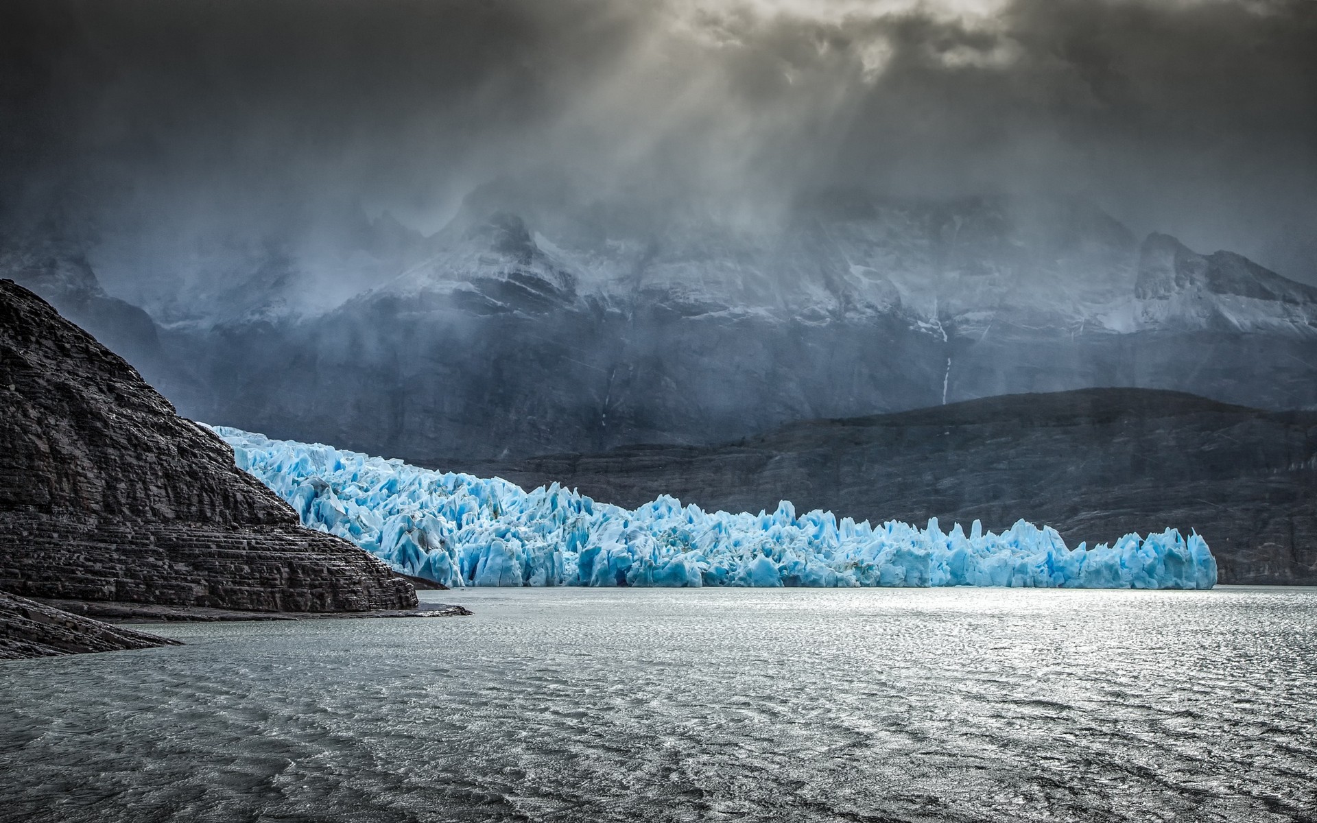 General 1920x1200 landscape nature glacier Chile Patagonia lake rocks erosion sun rays mountains mist ice dark clouds cyan gray South America cold outdoors