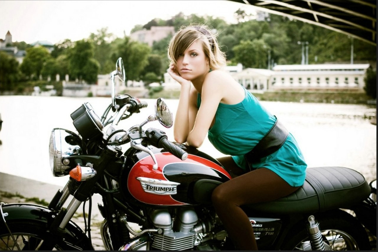 People 1280x853 motorcycle women with motorcycles model vehicle Triumph looking at viewer sitting women outdoors women