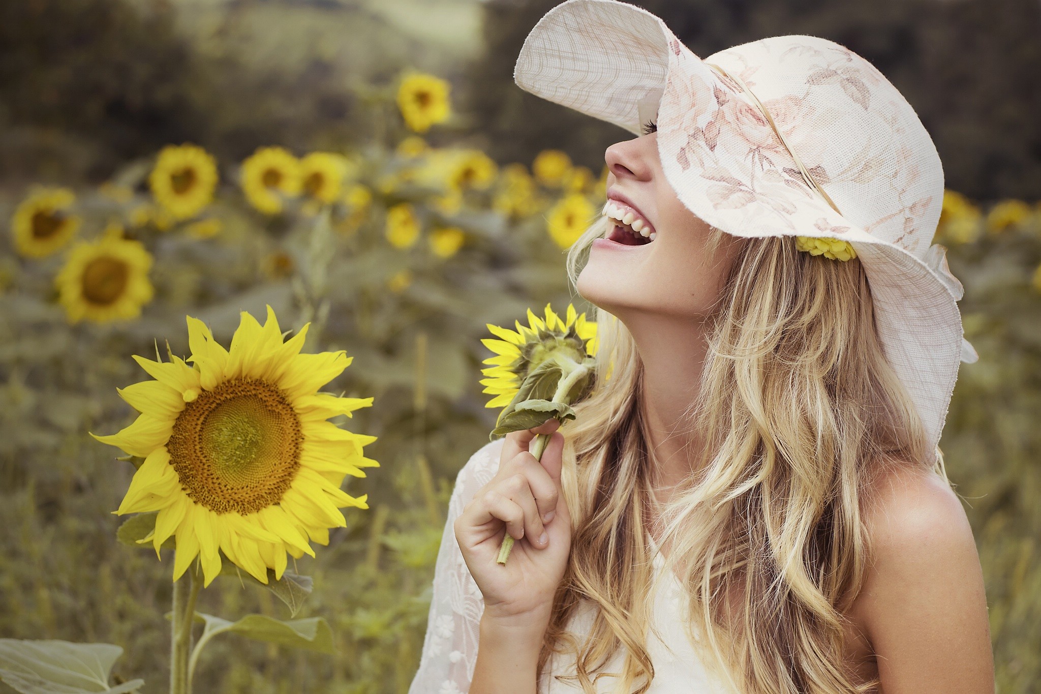 People 2048x1365 women model blonde sunflowers smiling hat long hair wavy hair women outdoors flowers yellow flowers outdoors plants open mouth women with hats