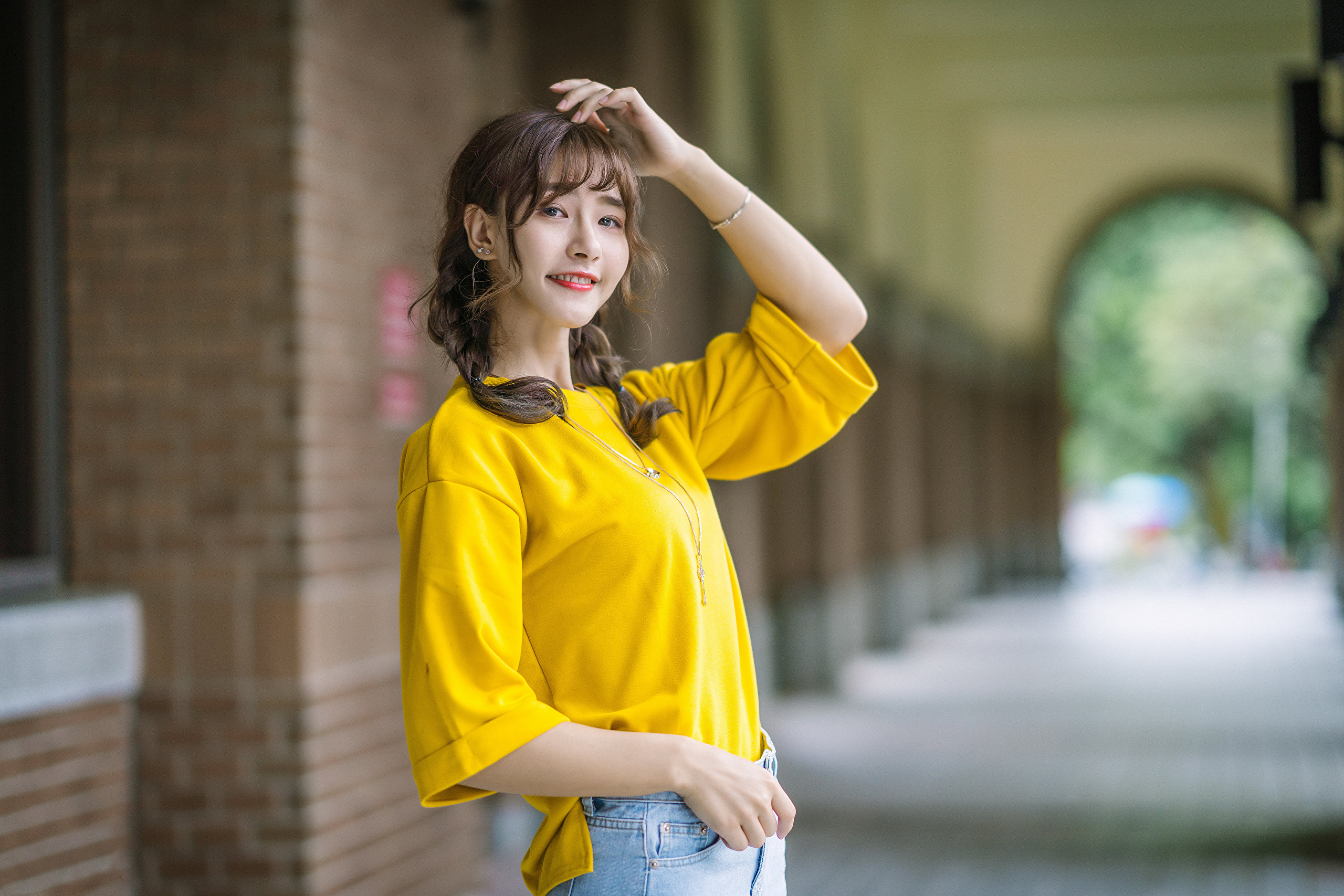 People 2560x1707 Asian model women women outdoors long hair dark hair depth of field twintails braids yellow shirt hallway bricks jeans necklace bracelets