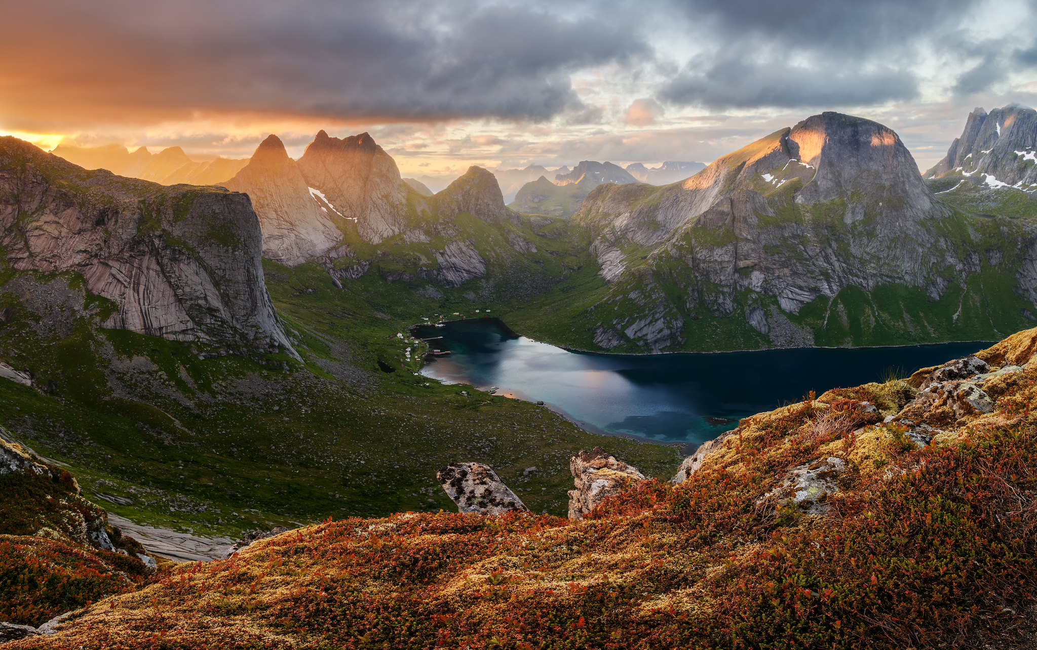 General 2047x1284 nature landscape mountains clouds grass plants rocks lake water far view sun rays sunset Lofoten Norway Mistah_Grape