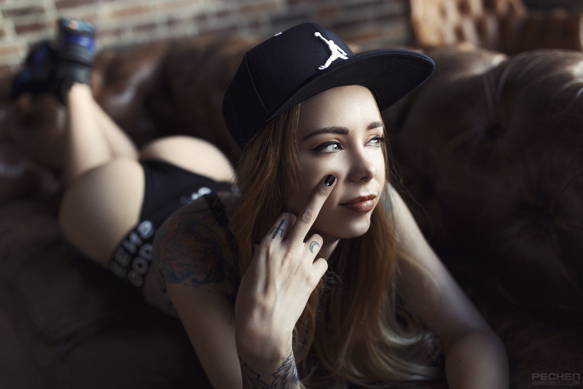 People 1920x1280 women ass baseball cap depth of field sneakers tattoo couch looking away black nails Ura Pechen underwear Natalia Shardina blonde middle finger God Save Queens lying on front